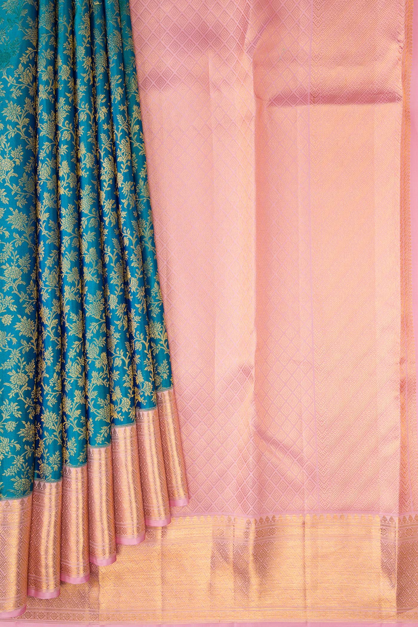 Pleats and pallu of Teal Kanchipuram Silk Saree with Zari Brocade on the body and Zari Border. 