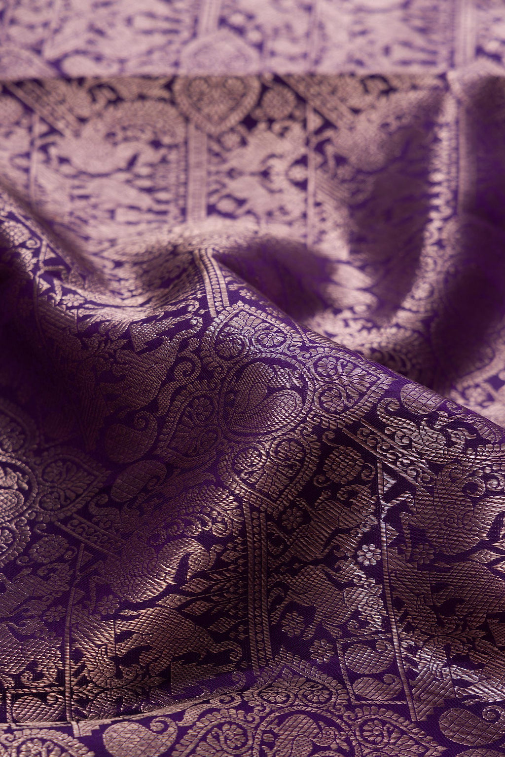 Close up of Navy Blue Kanchipuram Silk Saree with Zari Brocade on the body and Zari Border.  displaying folds