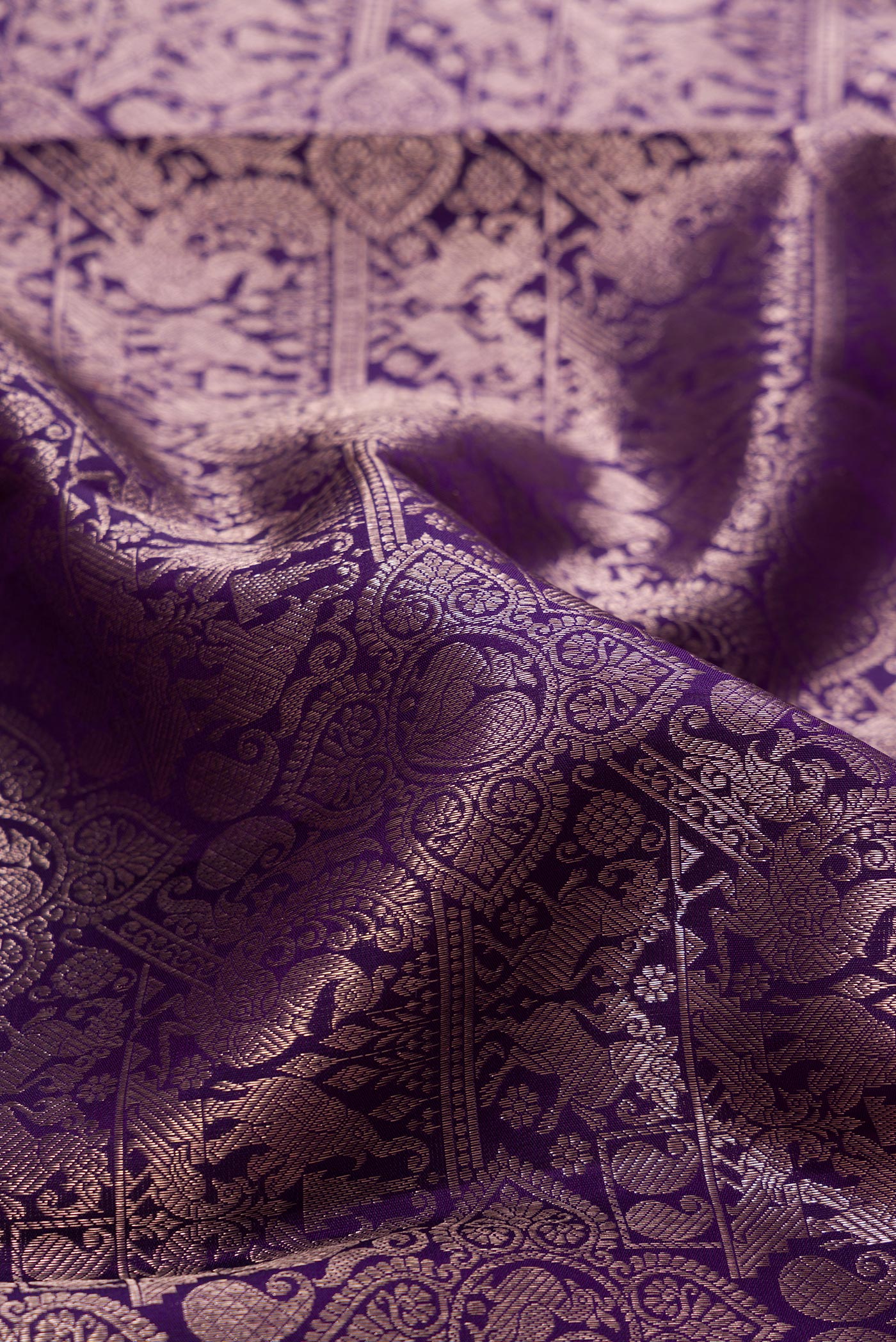 Close up of Navy Blue Kanchipuram Silk Saree with Zari Brocade on the body and Zari Border.  displaying folds