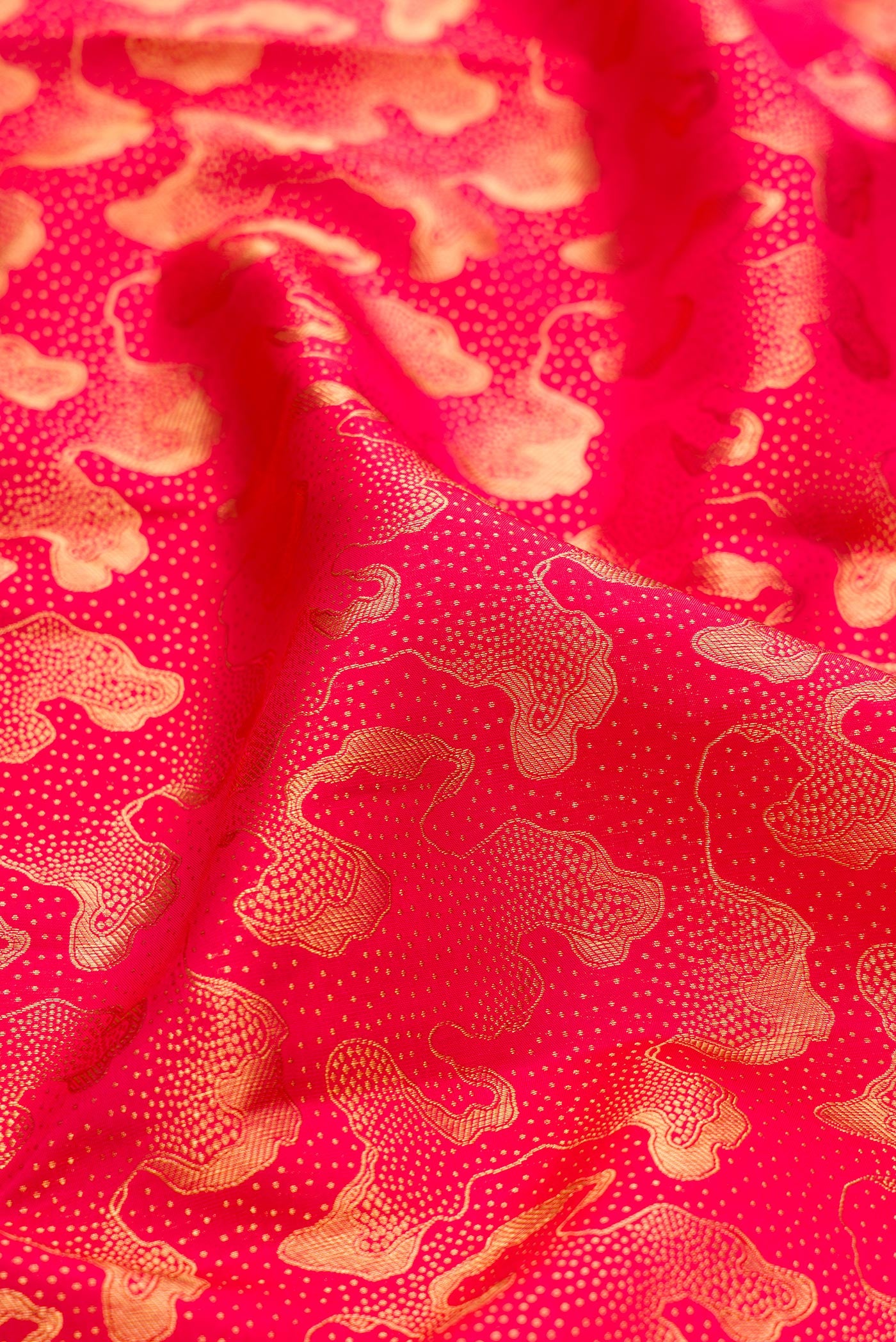 Close up of Dark Pink Kanchipuram Silk Saree with Zari Brocade on the body and Zari Border.  displaying folds