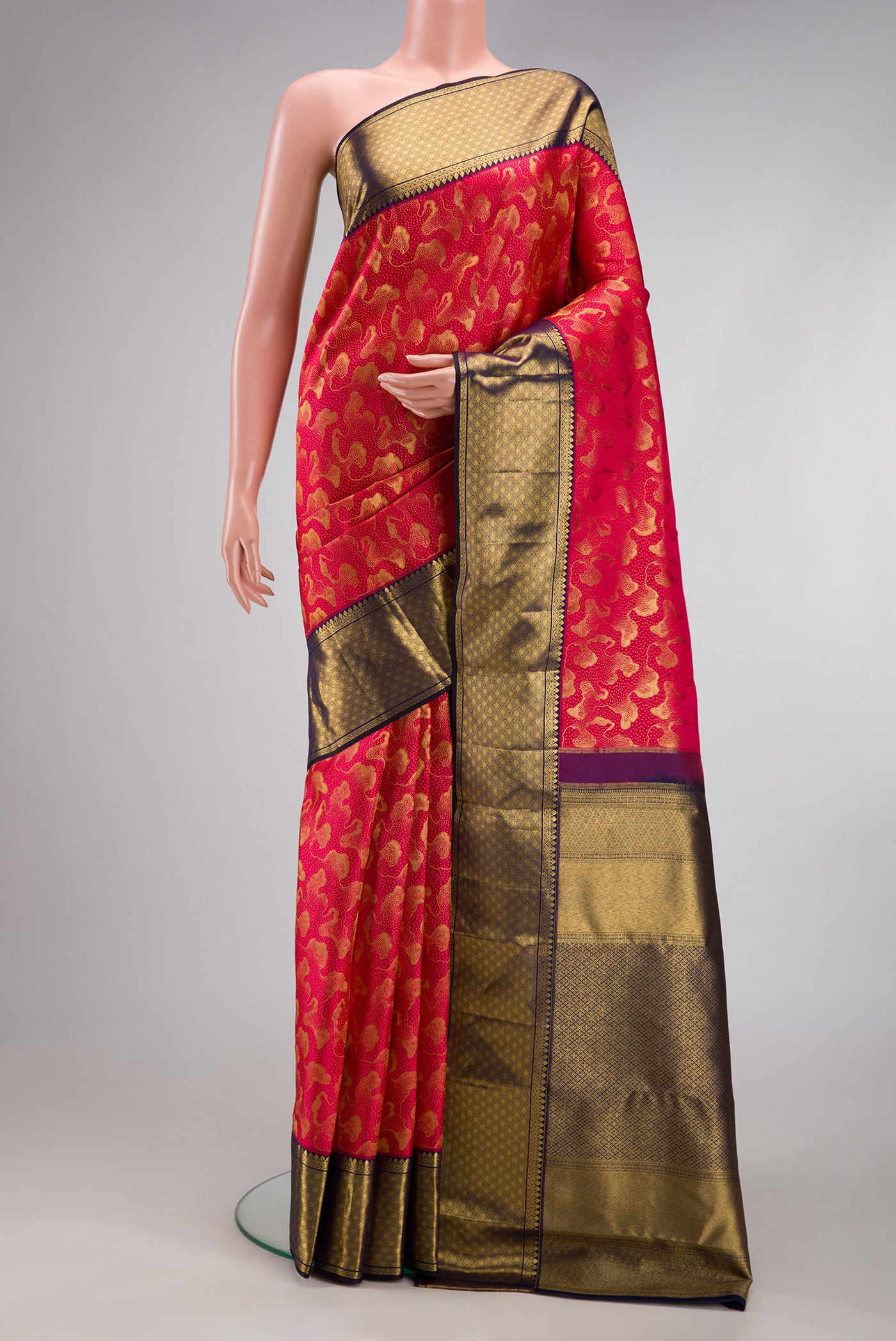 Dark Pink Kanchipuram Silk Saree with Zari Brocade on the body and Zari Border.  displayed on a mannequin