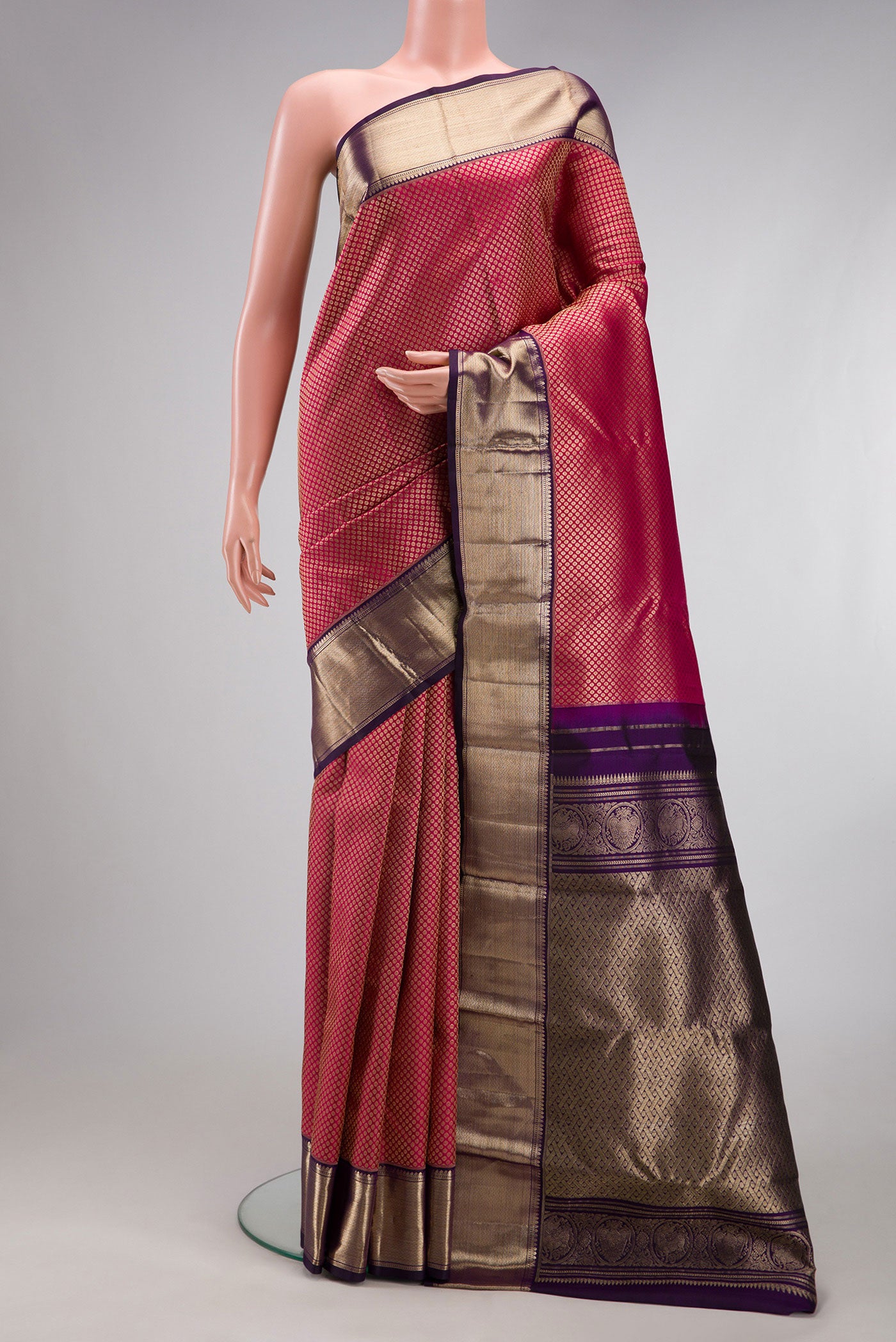 Rani Pink Kanchipuram Silk Saree with Zari Brocade on the body and Zari Border.  displayed on a mannequin