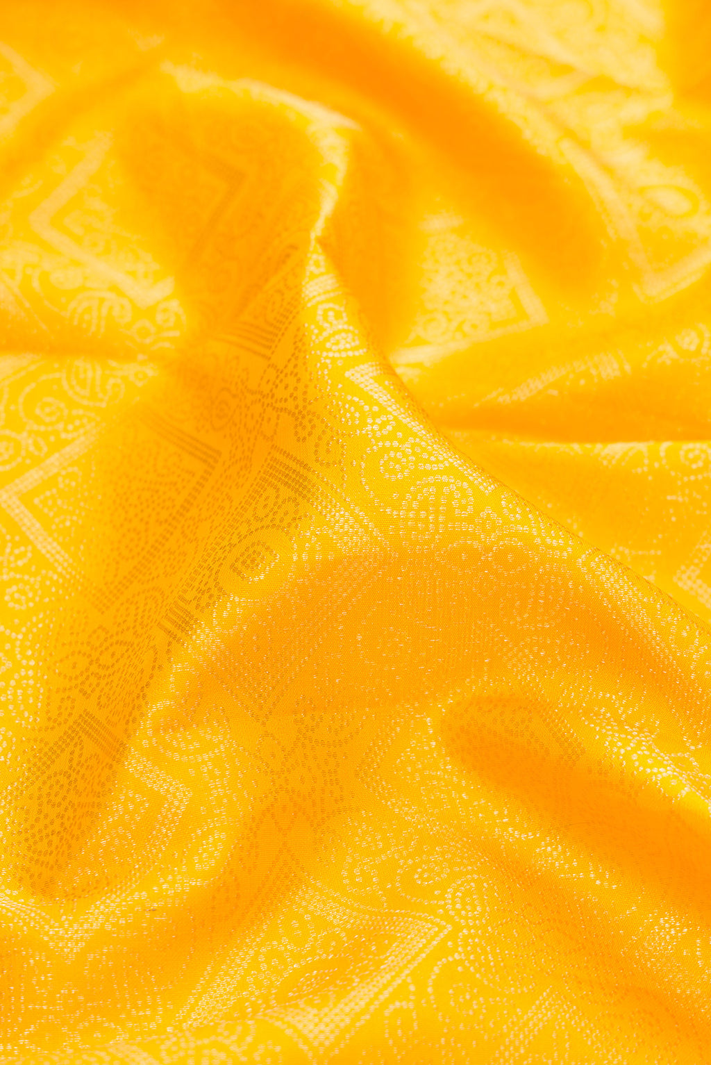 Close up of Yellow Kanjivaram Silk Saree with Zari Brocade on the body and Zari Border.  displaying folds