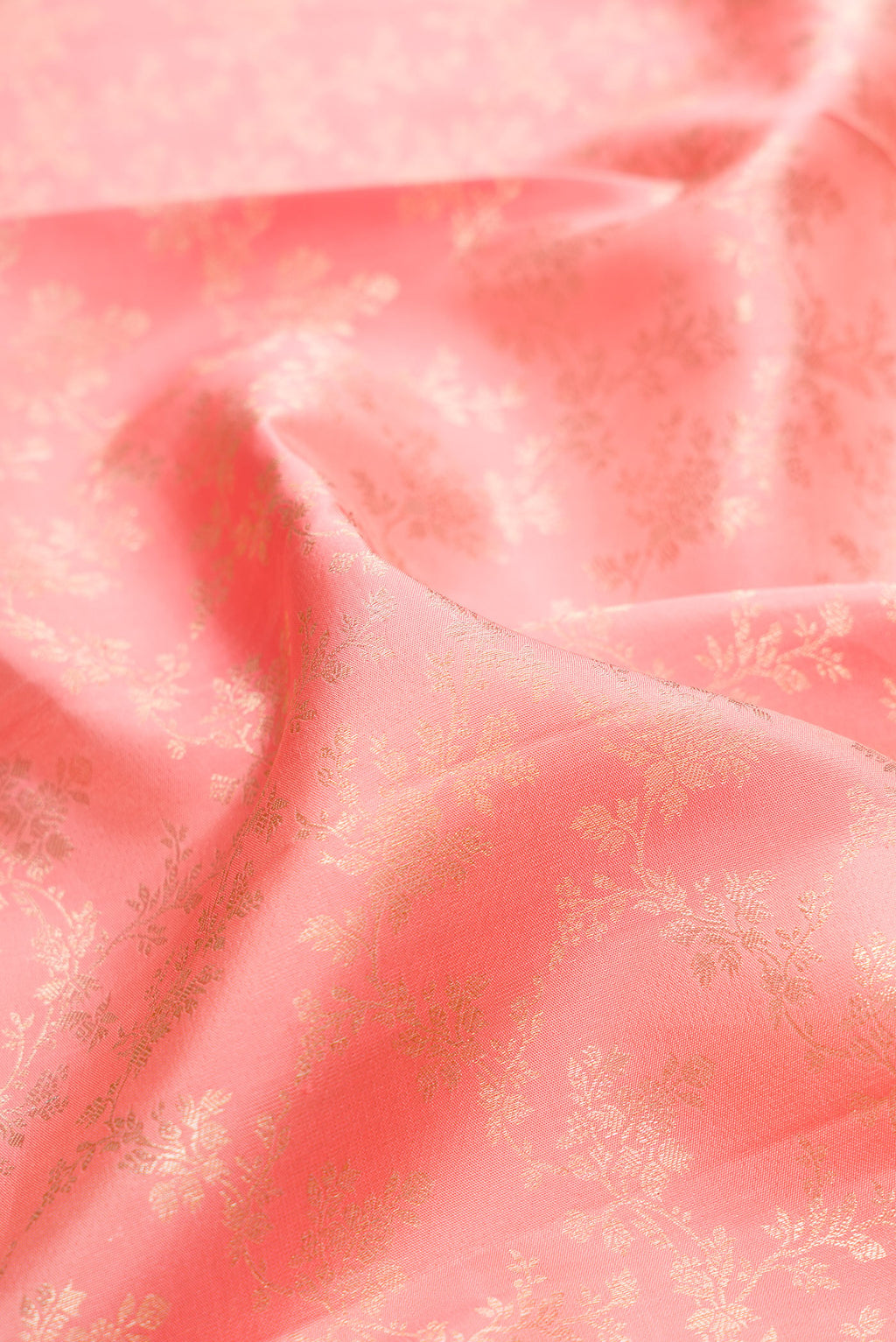 Close up of Pure Silk Peach Kanjivaram Saree with Zari Brocade on the body and Zari Border.  displaying folds