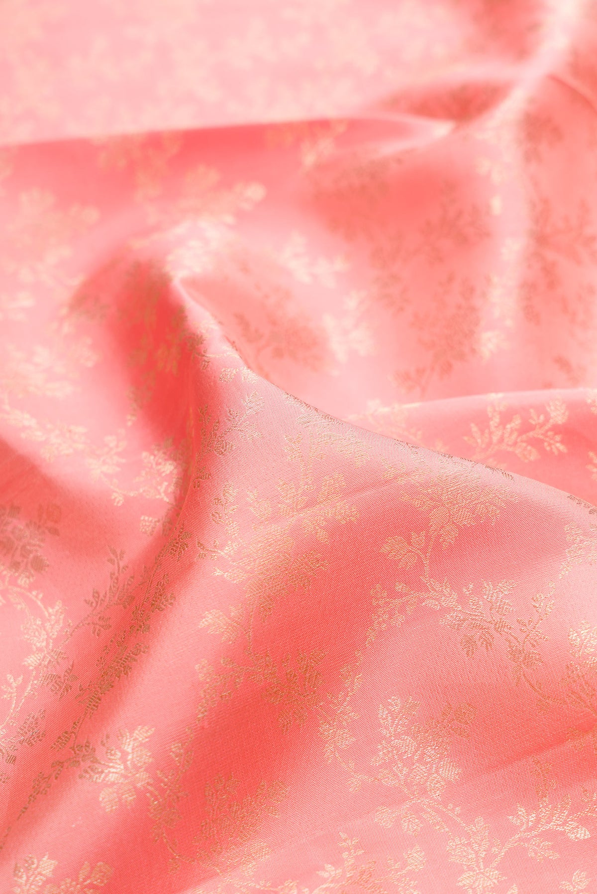 Close up of Pure Silk Peach Kanjivaram Saree with Zari Brocade on the body and Zari Border.  displaying folds