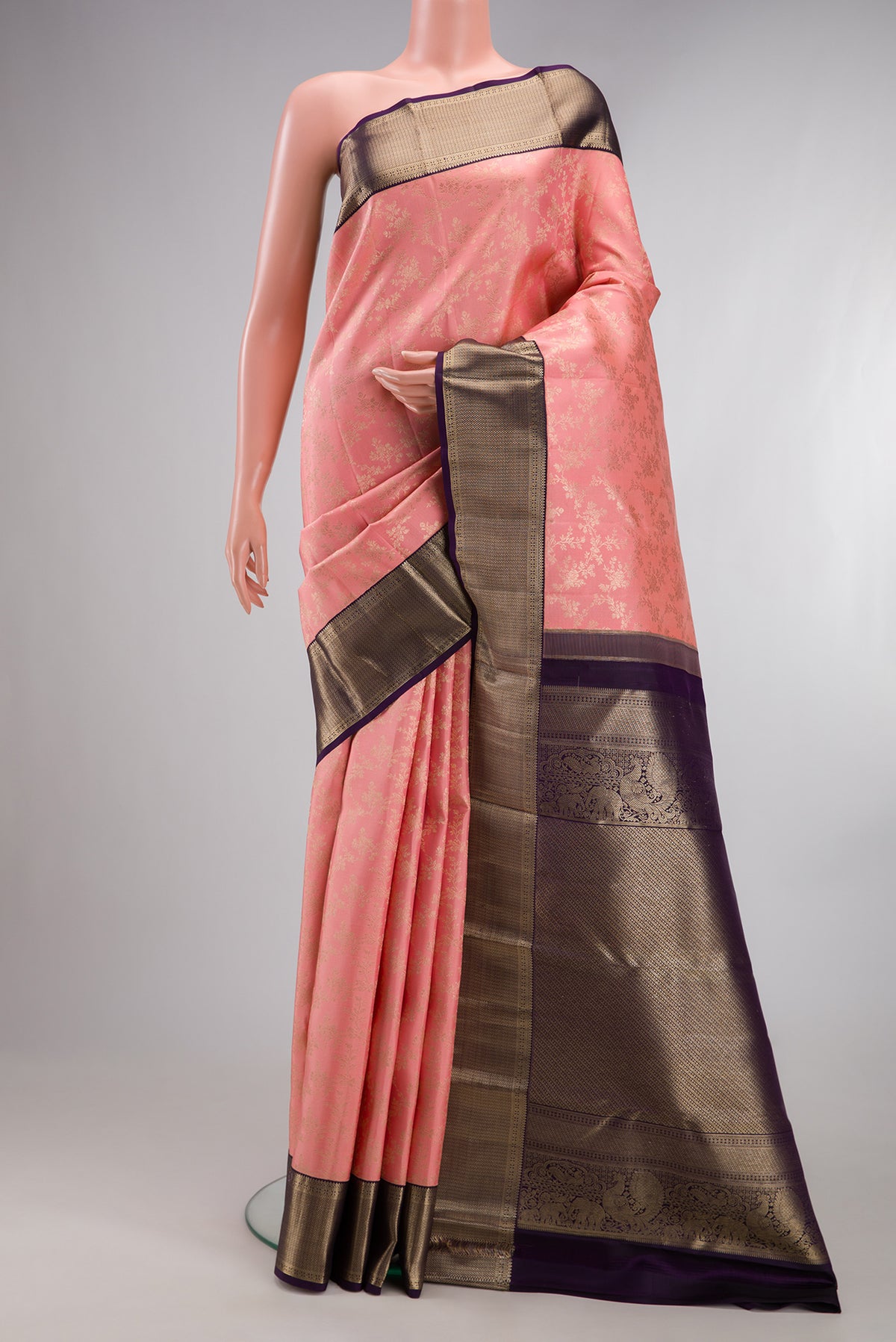 Pure Silk Peach Kanjivaram Saree with Zari Brocade on the body and Zari Border.  displayed on a mannequin