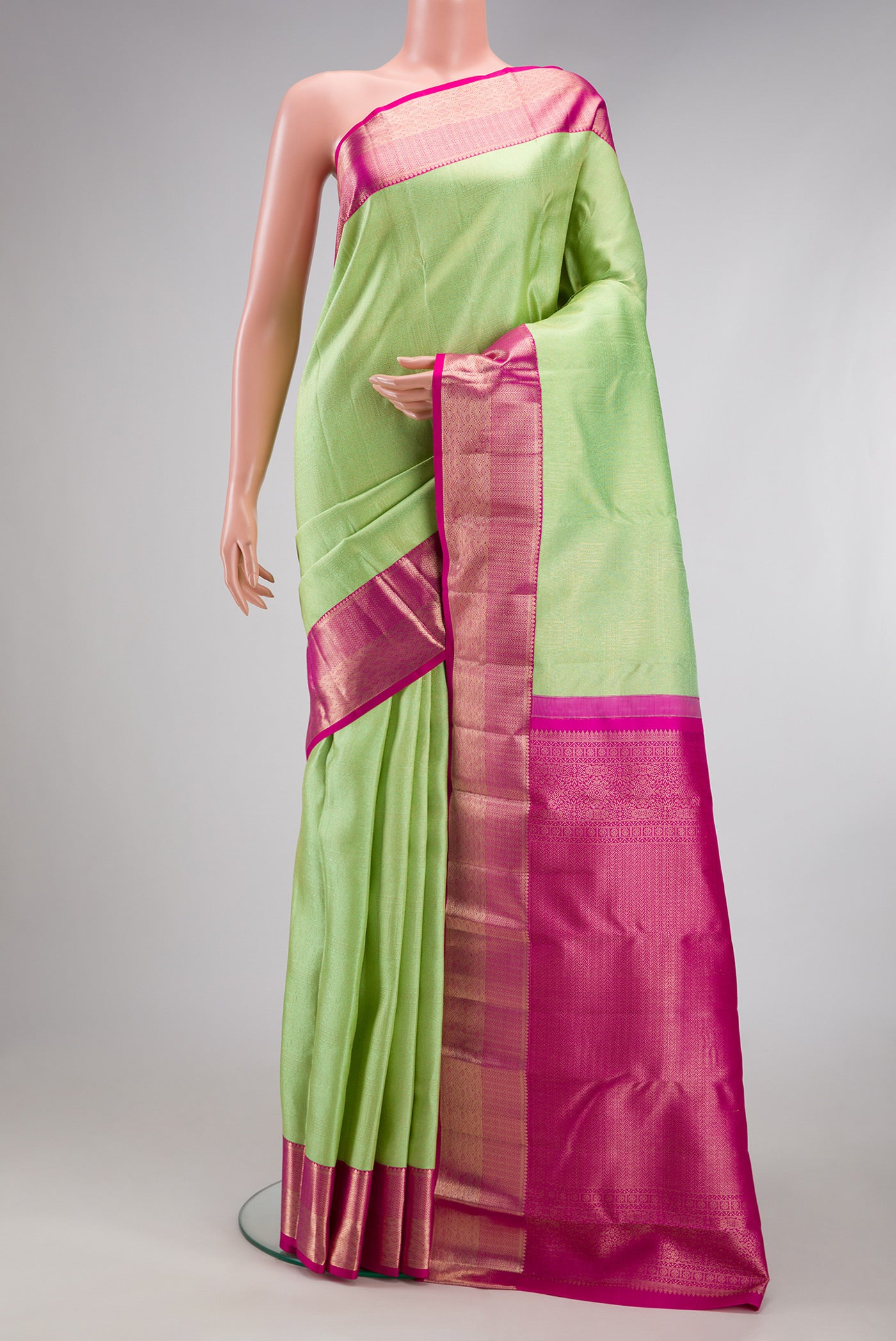 Mint Green Kanjivaram Silk Saree with Zari Brocade on the body and Zari Border.  displayed on a mannequin