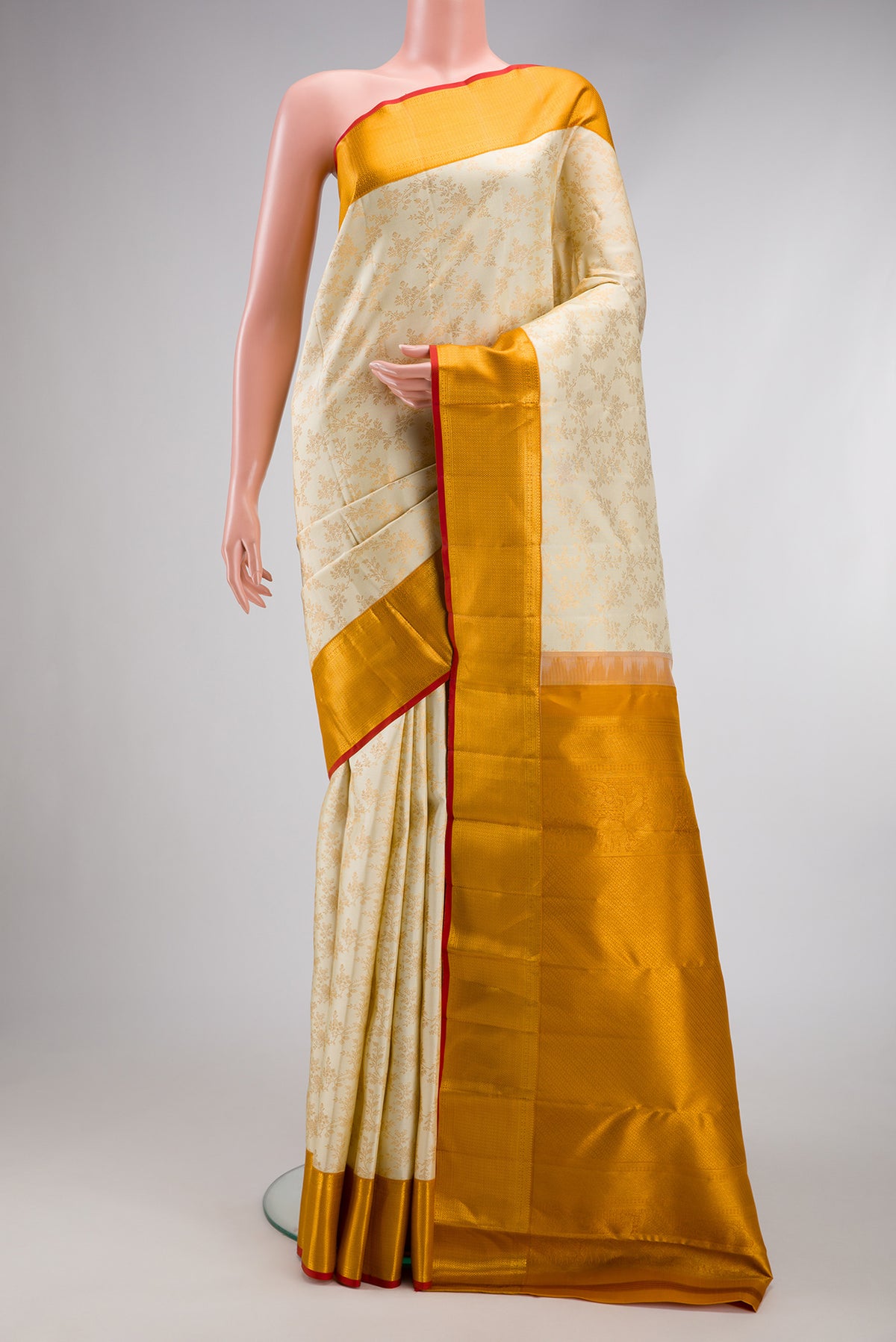 Off White Kanjivaram Silk Saree with Zari Brocade on the body and Zari Border.  displayed on a mannequin