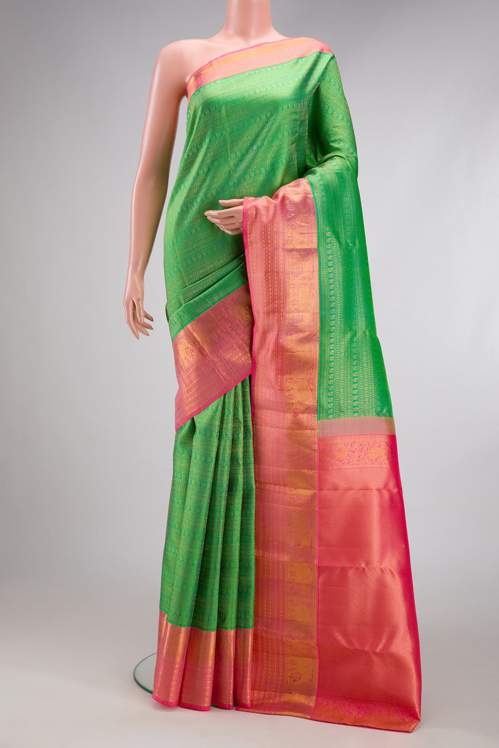 Green Kanjivaram Silk Saree with Zari Brocade on the body and Zari Border.  displayed on a mannequin