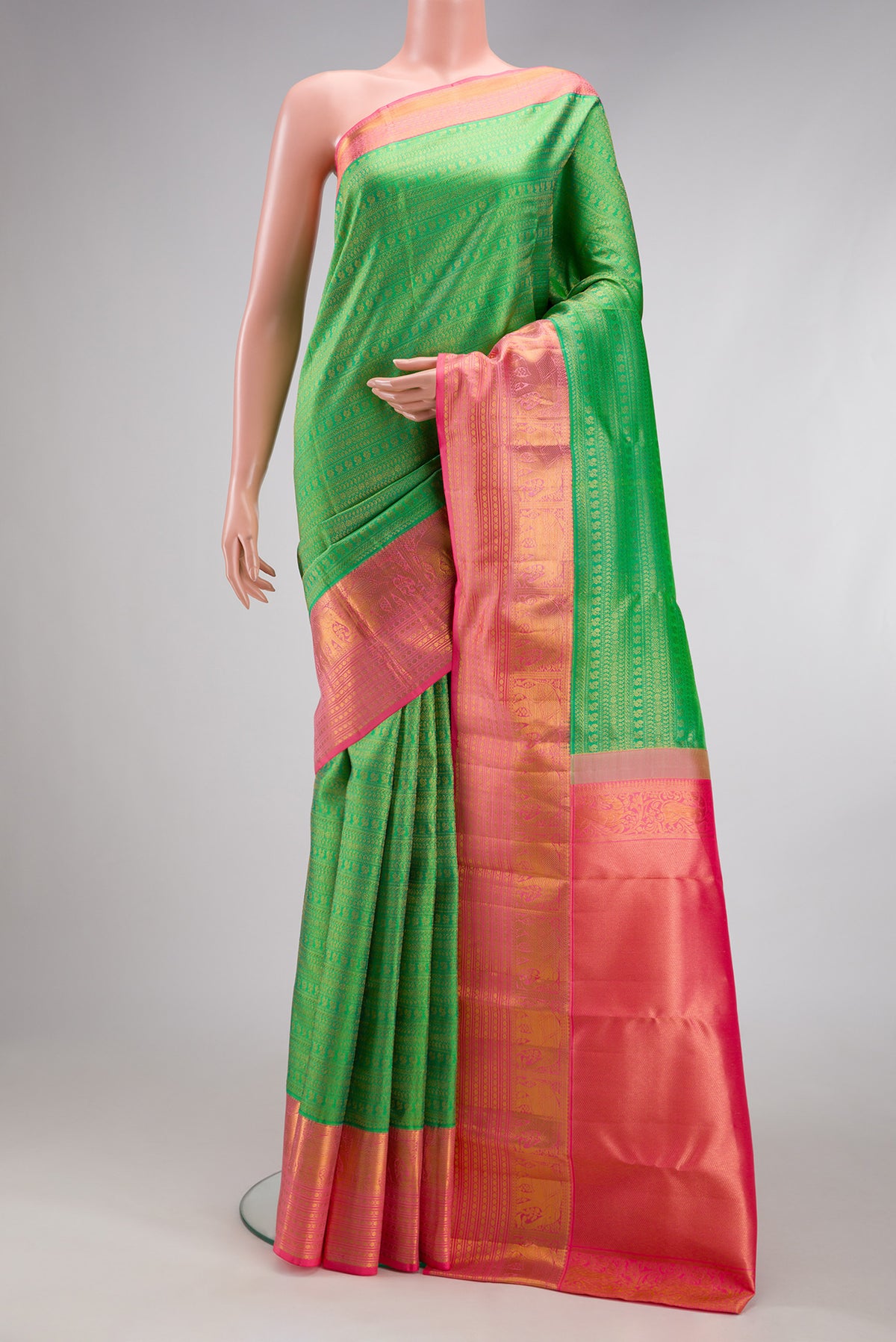 Green Kanjivaram Silk Saree with Zari Brocade on the body and Zari Border.  displayed on a mannequin