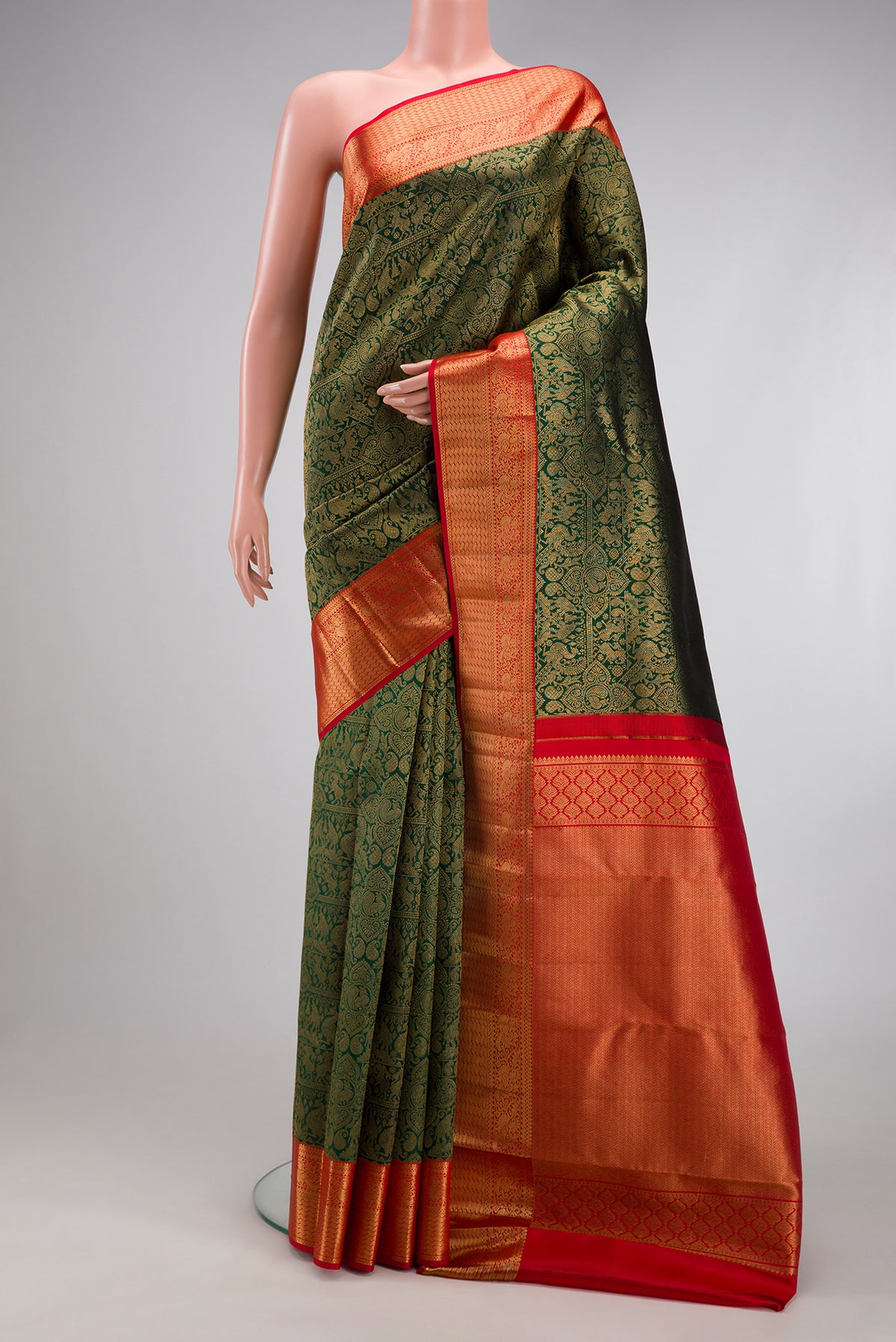 Bottle Green Kanjivaram Silk Saree with Zari Brocade on the body and Zari Border.  displayed on a mannequin