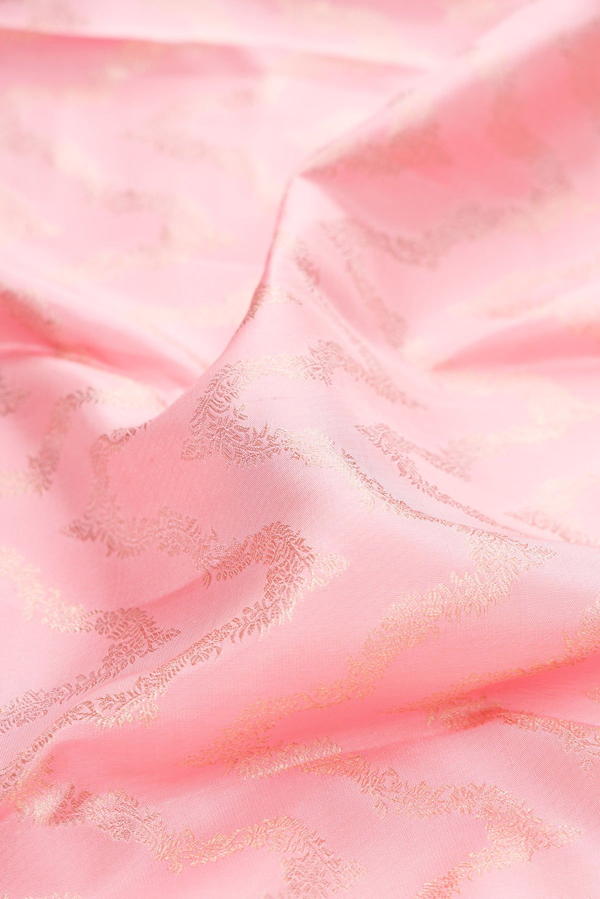 Close up of Rose pink Kanjivaram Silk Saree with Zari Brocade on the body and Zari Border.  displaying folds