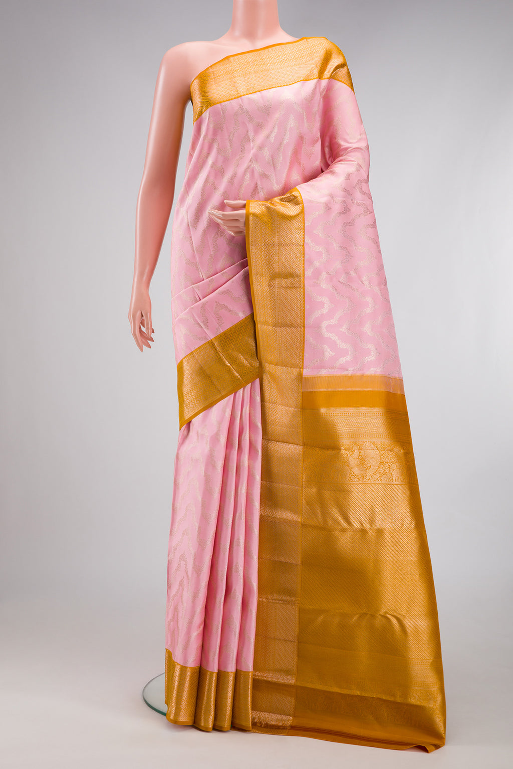 Rose pink Kanjivaram Silk Saree with Zari Brocade on the body and Zari Border.  displayed on a mannequin