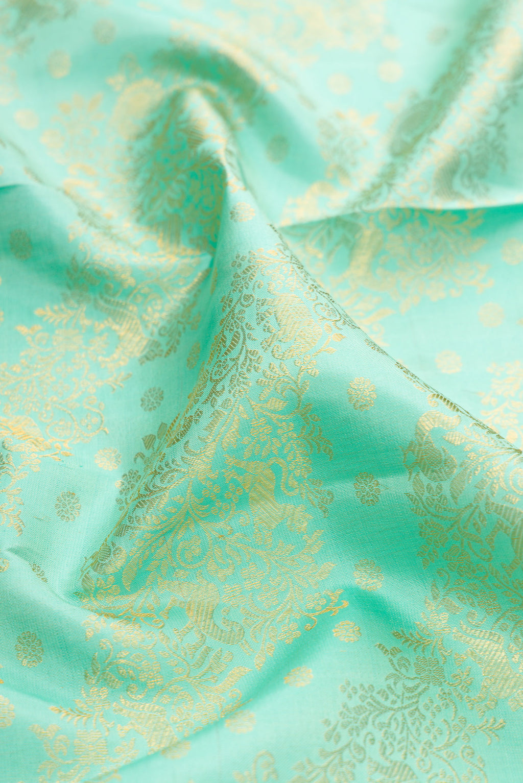 Close up of Sea Green Kanjivaram Silk Saree with Zari Brocade on the body and Zari Border.  displaying folds