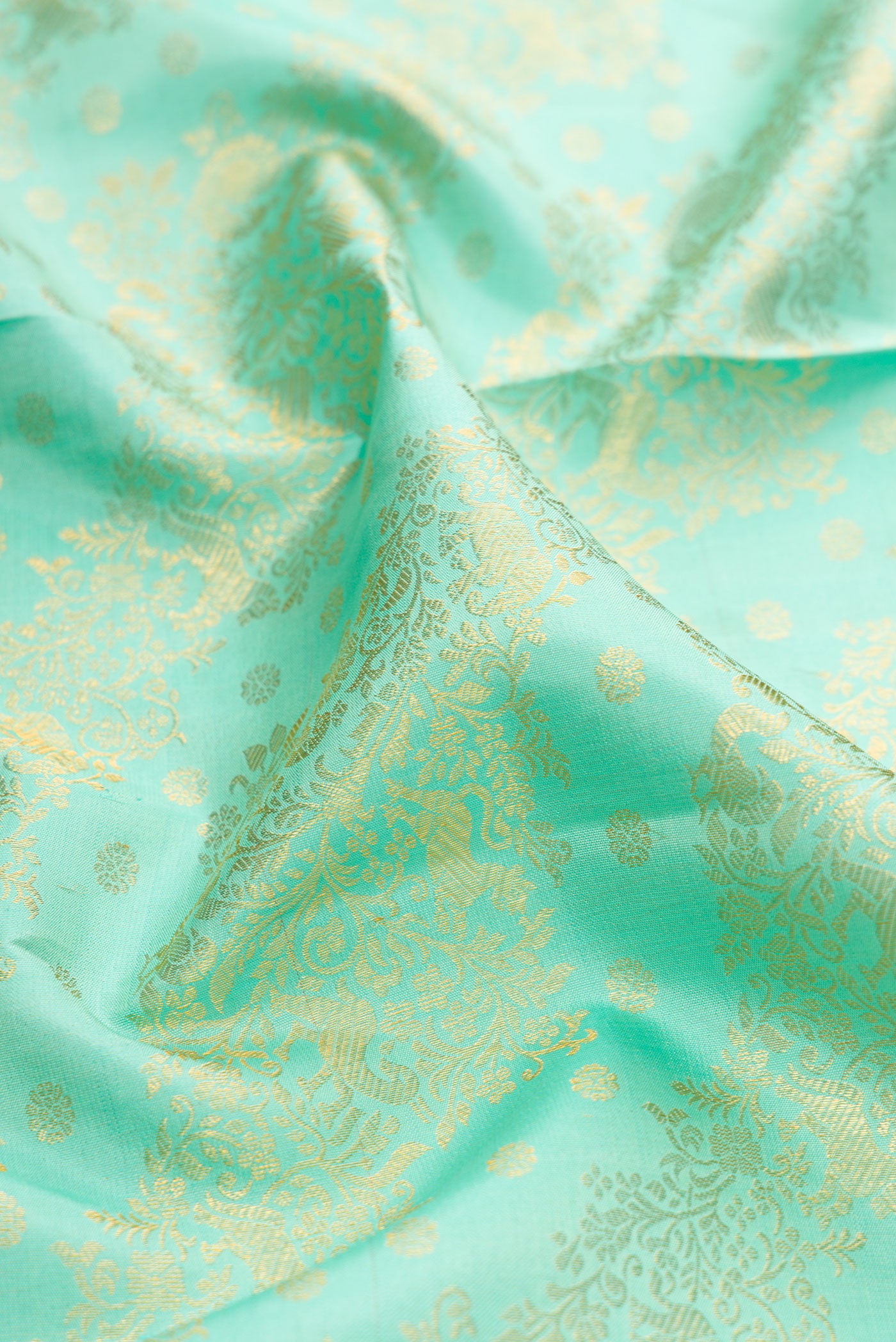 Close up of Sea Green Kanjivaram Silk Saree with Zari Brocade on the body and Zari Border.  displaying folds