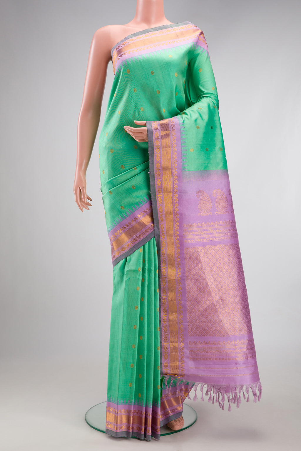 Sea Green Gadwal Silk Saree with Zari Butta on the body and Zari Border.  displayed on a mannequin