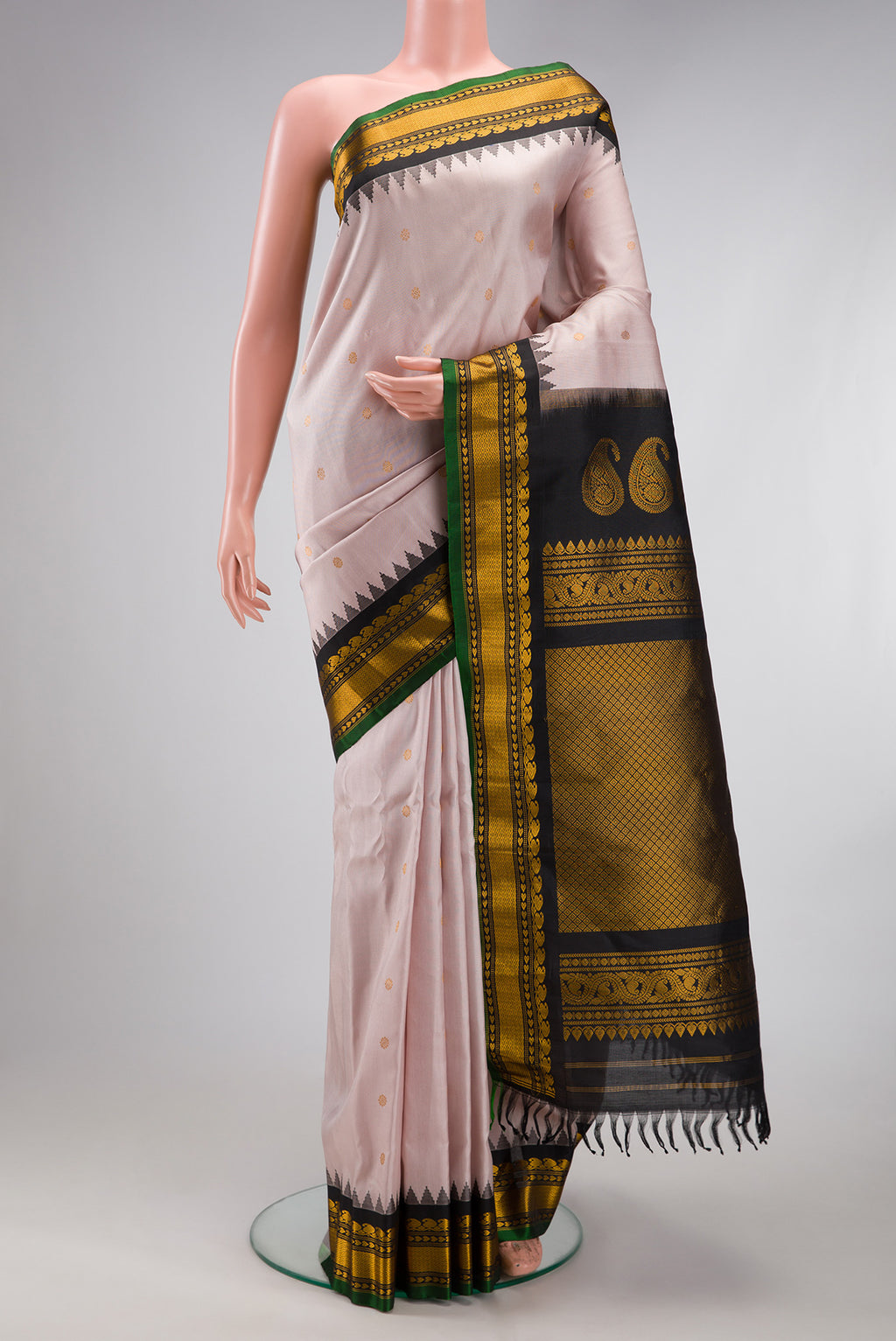 Rose Gold Gadwal Silk Saree with Zari Butta on the body and Temple Border.  displayed on a mannequin