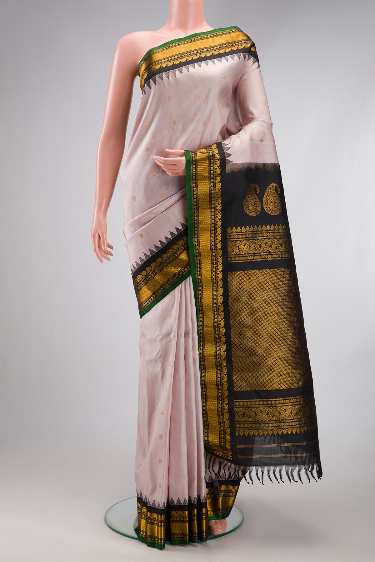Rose Gold Gadwal Silk Saree with Zari Butta on the body and Temple Border.  displayed on a mannequin