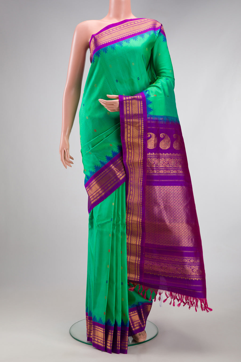 Green Gadwal Silk Saree with Thread Butta on the body and Zari Border.  displayed on a mannequin