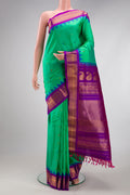 Green Gadwal Silk Saree with Thread Butta on the body and Zari Border.  displayed on a mannequin