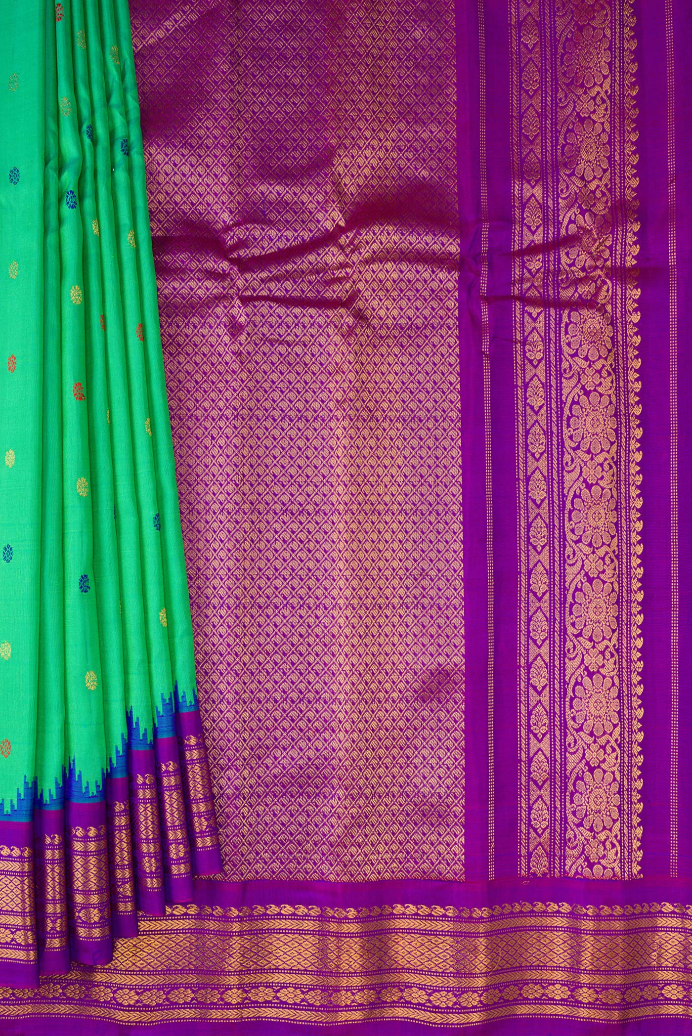 Pleats and pallu of Green Gadwal Silk Saree with Thread Butta on the body and Zari Border. 