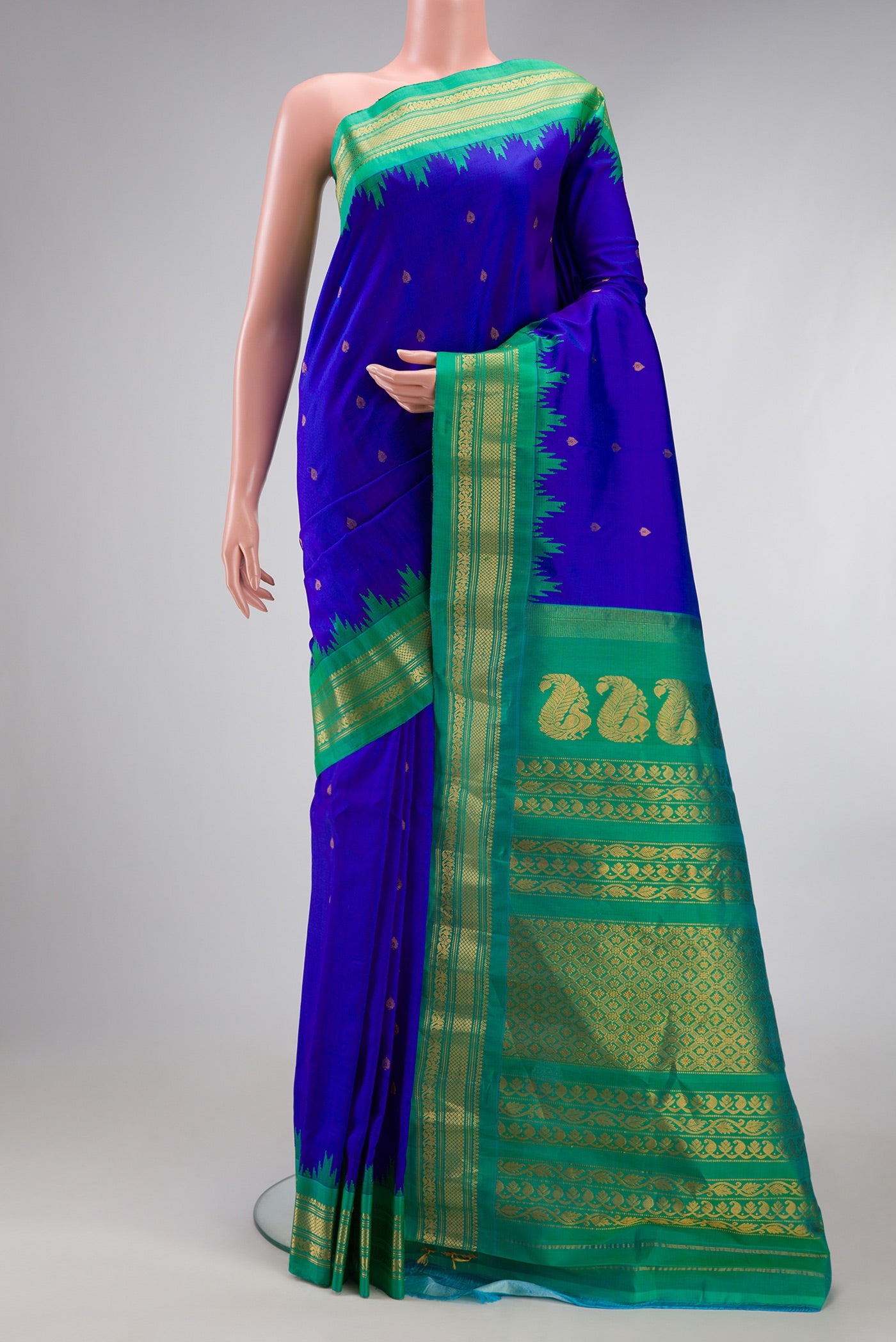 Royal Blue Gadwal Silk Saree with Zari Butta on the body and Temple Border.  displayed on a mannequin