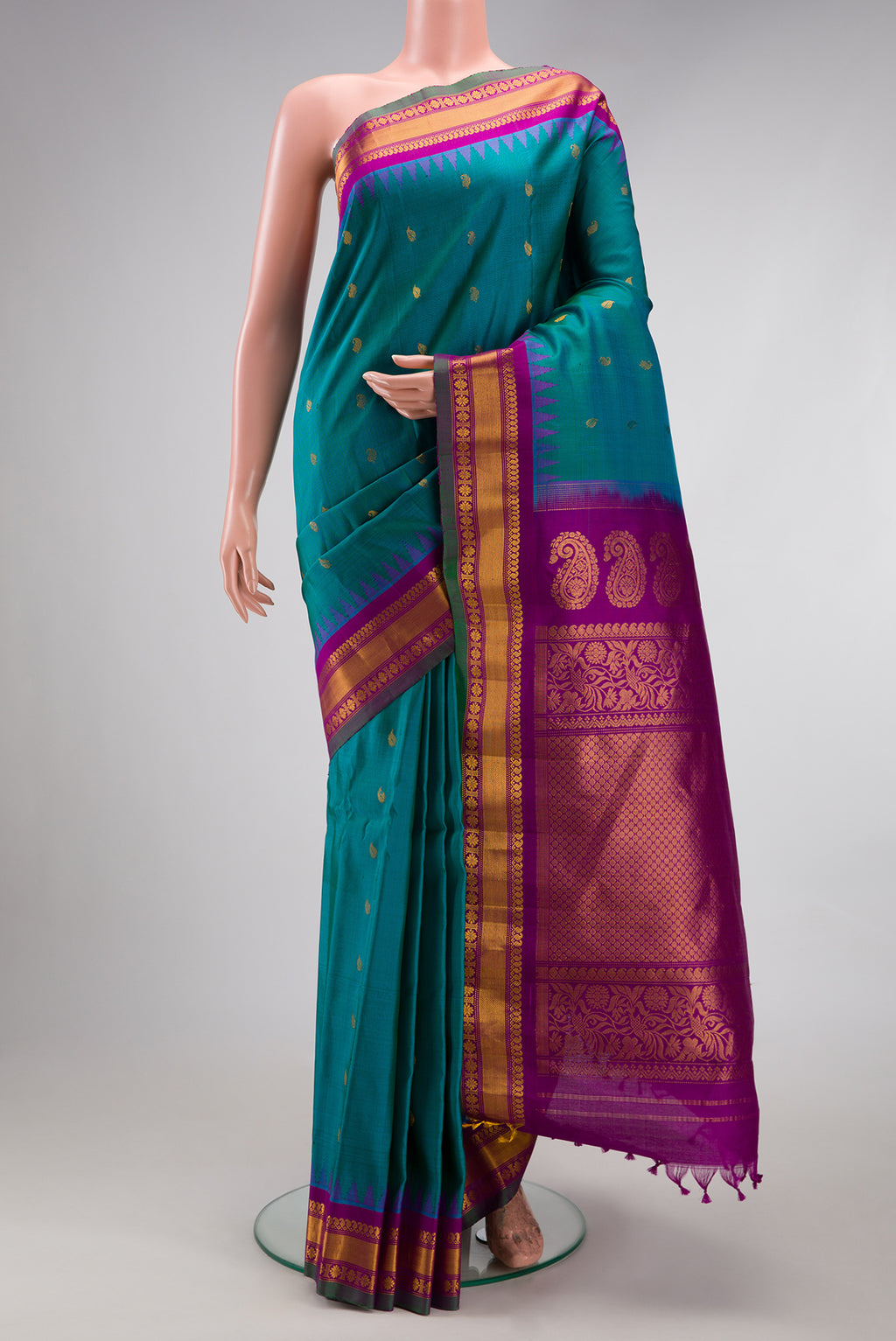 Peacock Blue Gadwal Silk Saree with Zari Butta on the body and Zari Border.  displayed on a mannequin