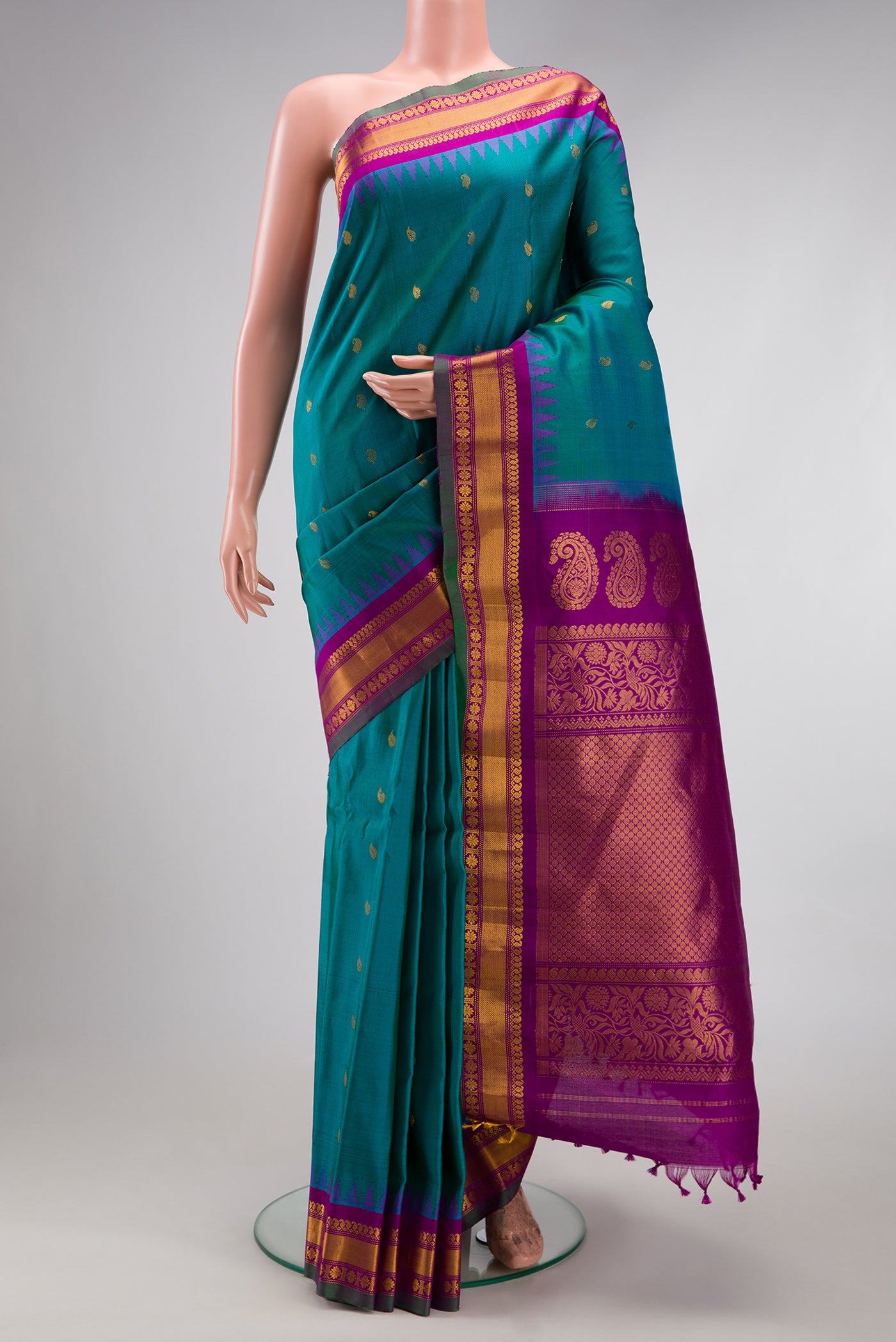 Peacock Blue Gadwal Silk Saree with Zari Butta on the body and Zari Border.  displayed on a mannequin