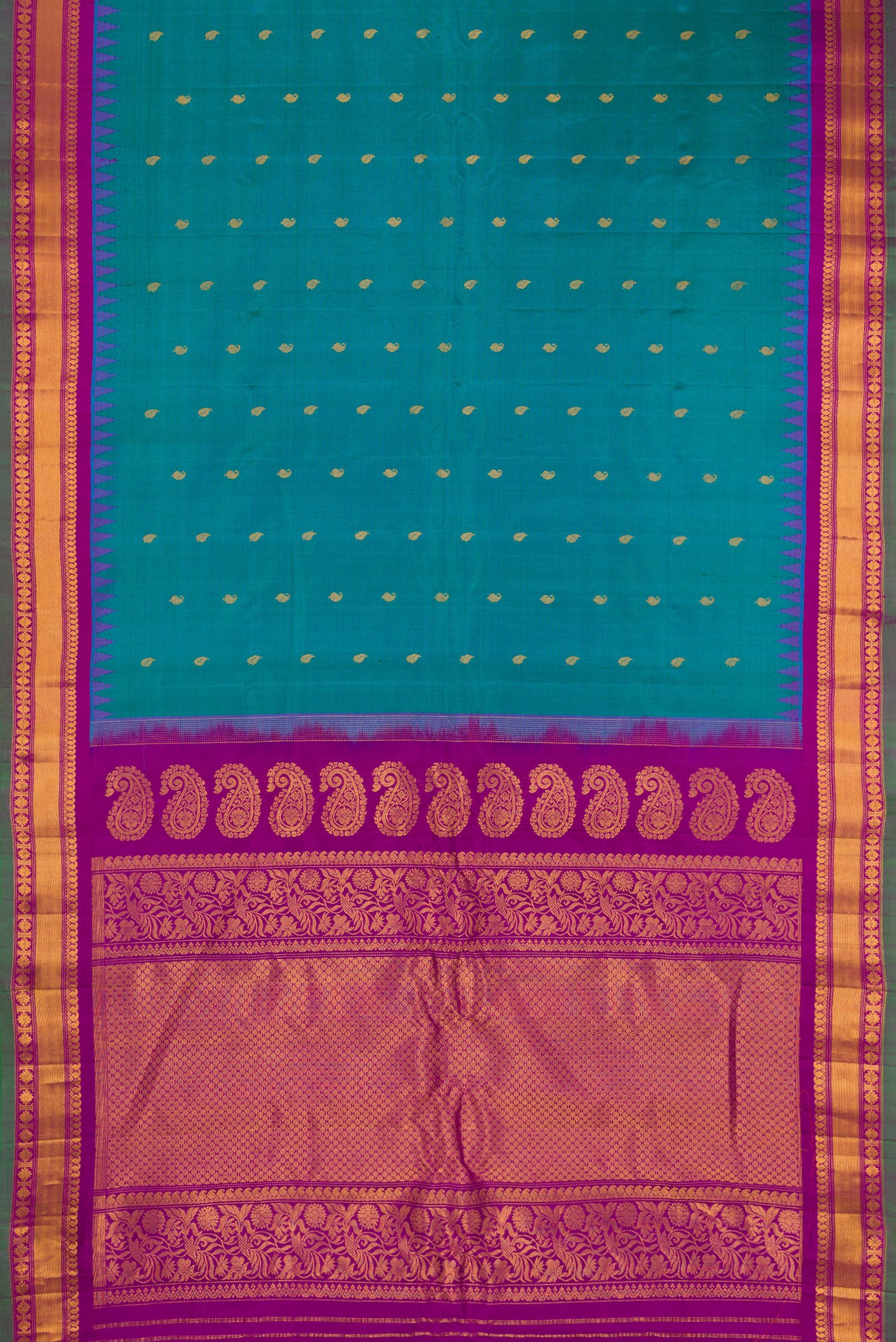 Flat view of Peacock Blue Gadwal Silk Saree with Zari Butta on the body and Zari Border. 