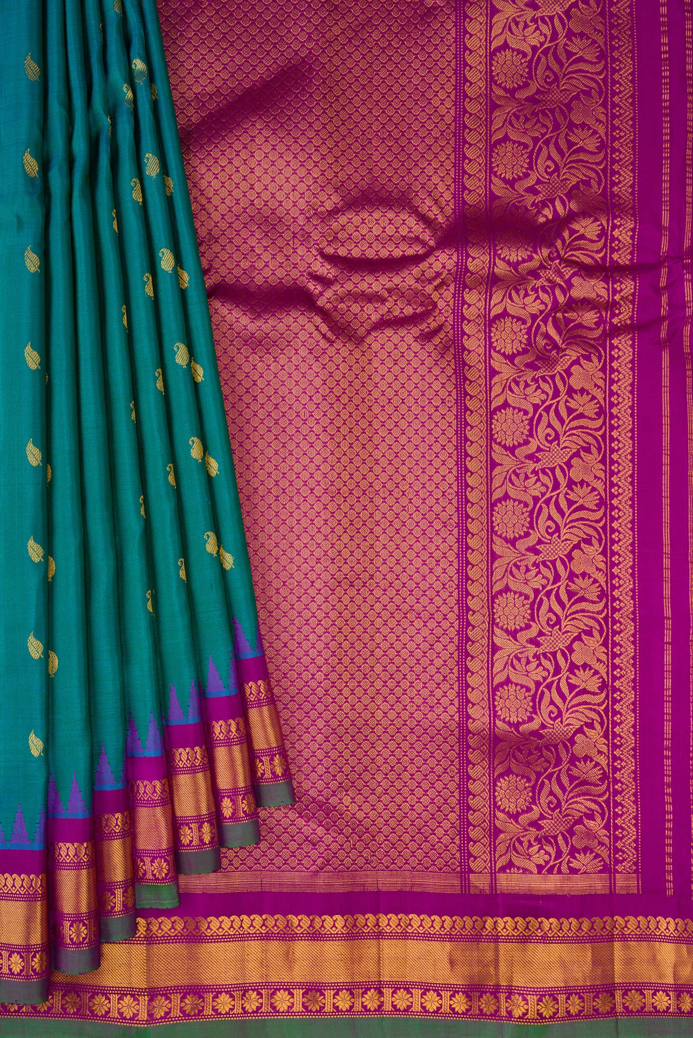 Pleats and pallu of Peacock Blue Gadwal Silk Saree with Zari Butta on the body and Zari Border. 
