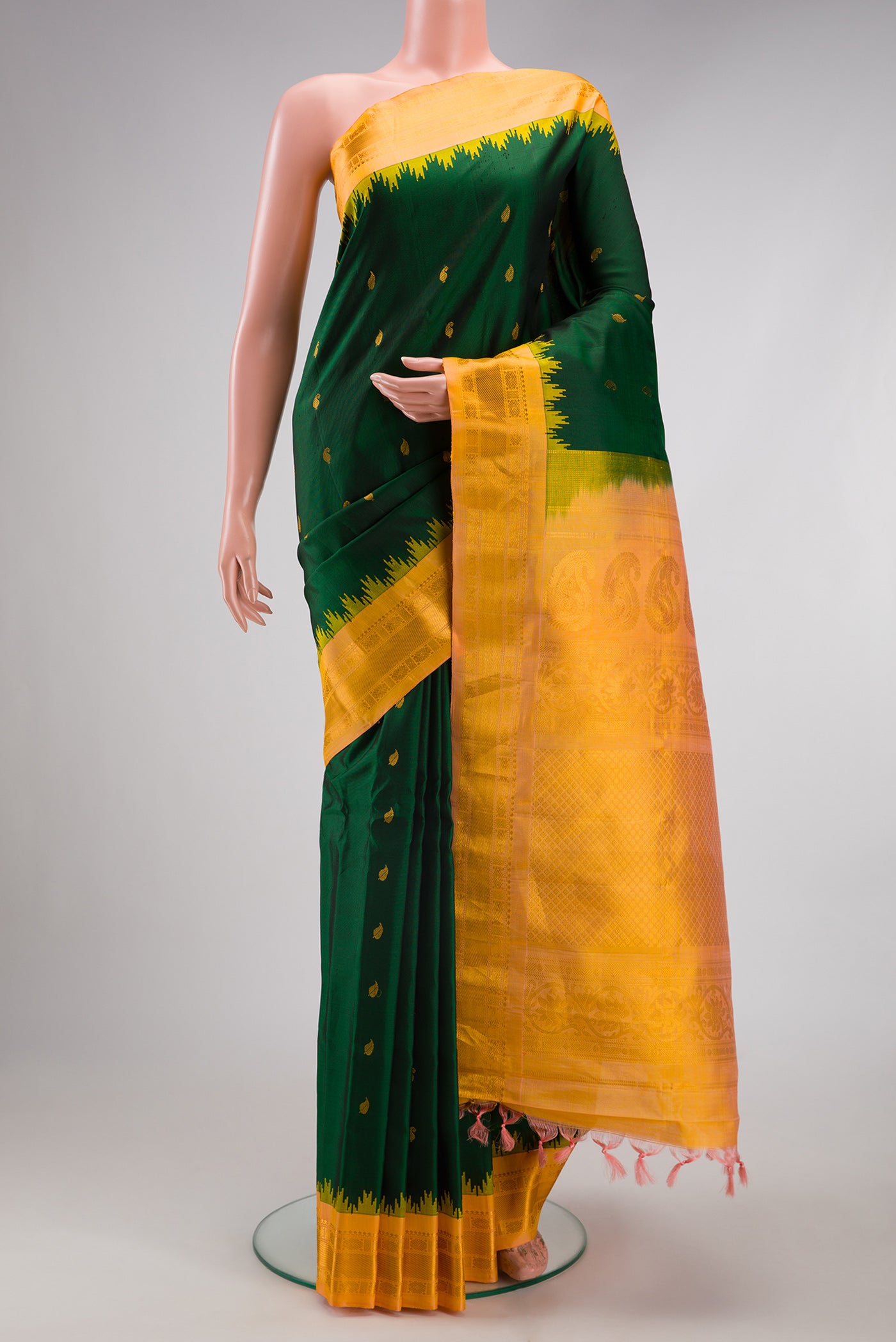 Bottle Green Gadwal Silk Saree with Zari Butta on the body and Zari Border.  displayed on a mannequin