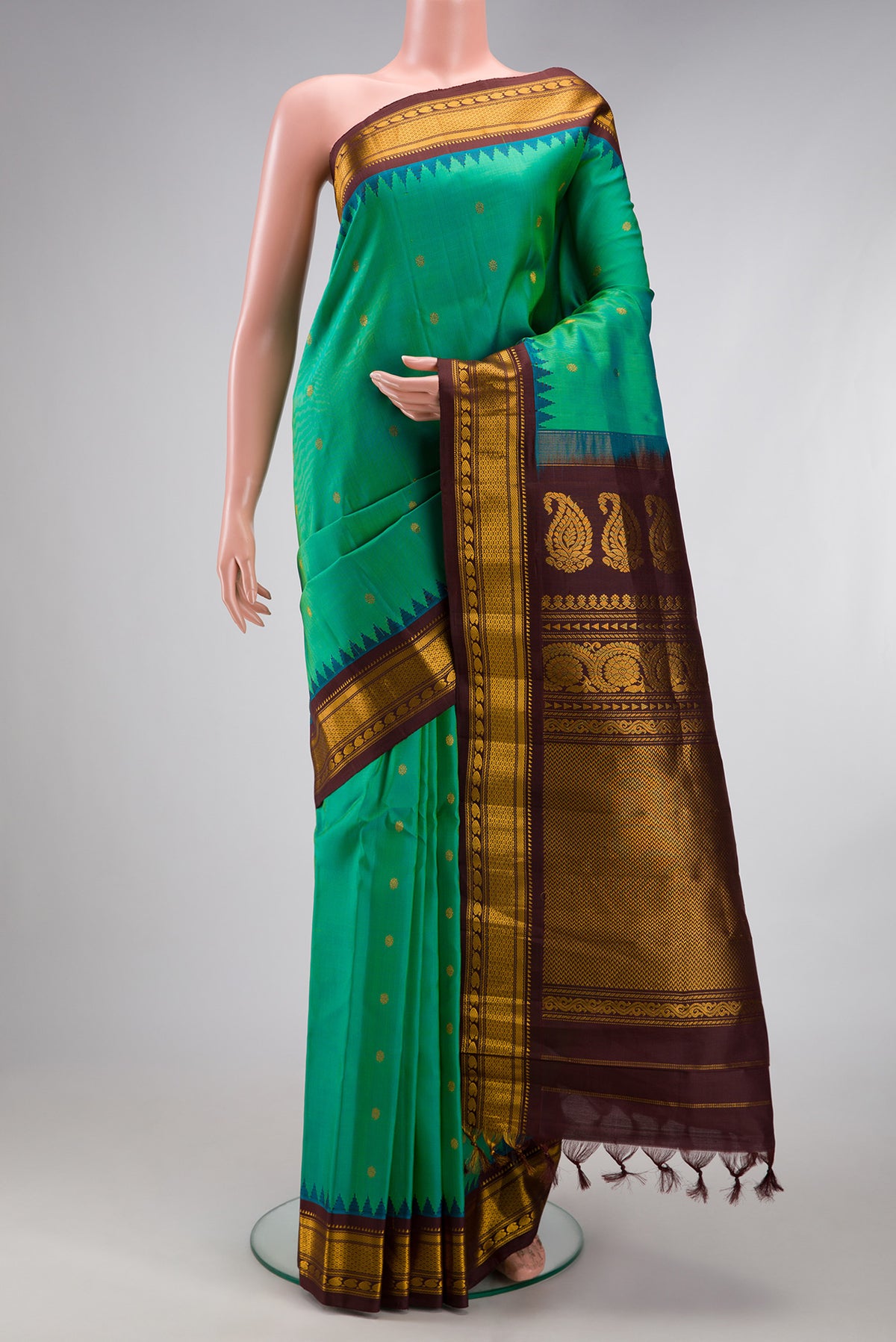 Sea Green Dual Tone Gadwal Silk Saree with Zari Butta on the body and Temple Border.  displayed on a mannequin