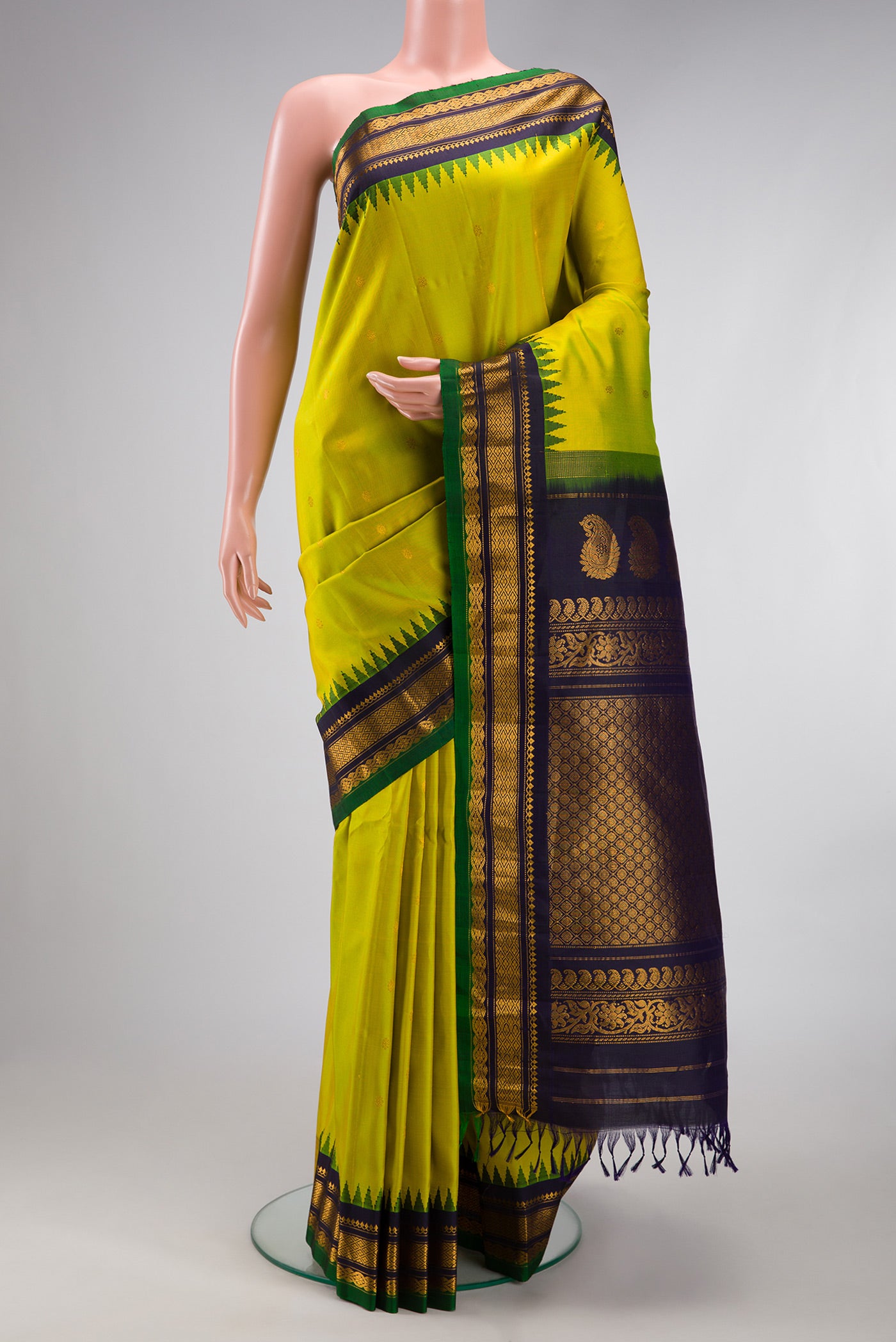 Parrot Green Gadwal Silk Saree with Zari Butta on the body and Temple Border.  displayed on a mannequin