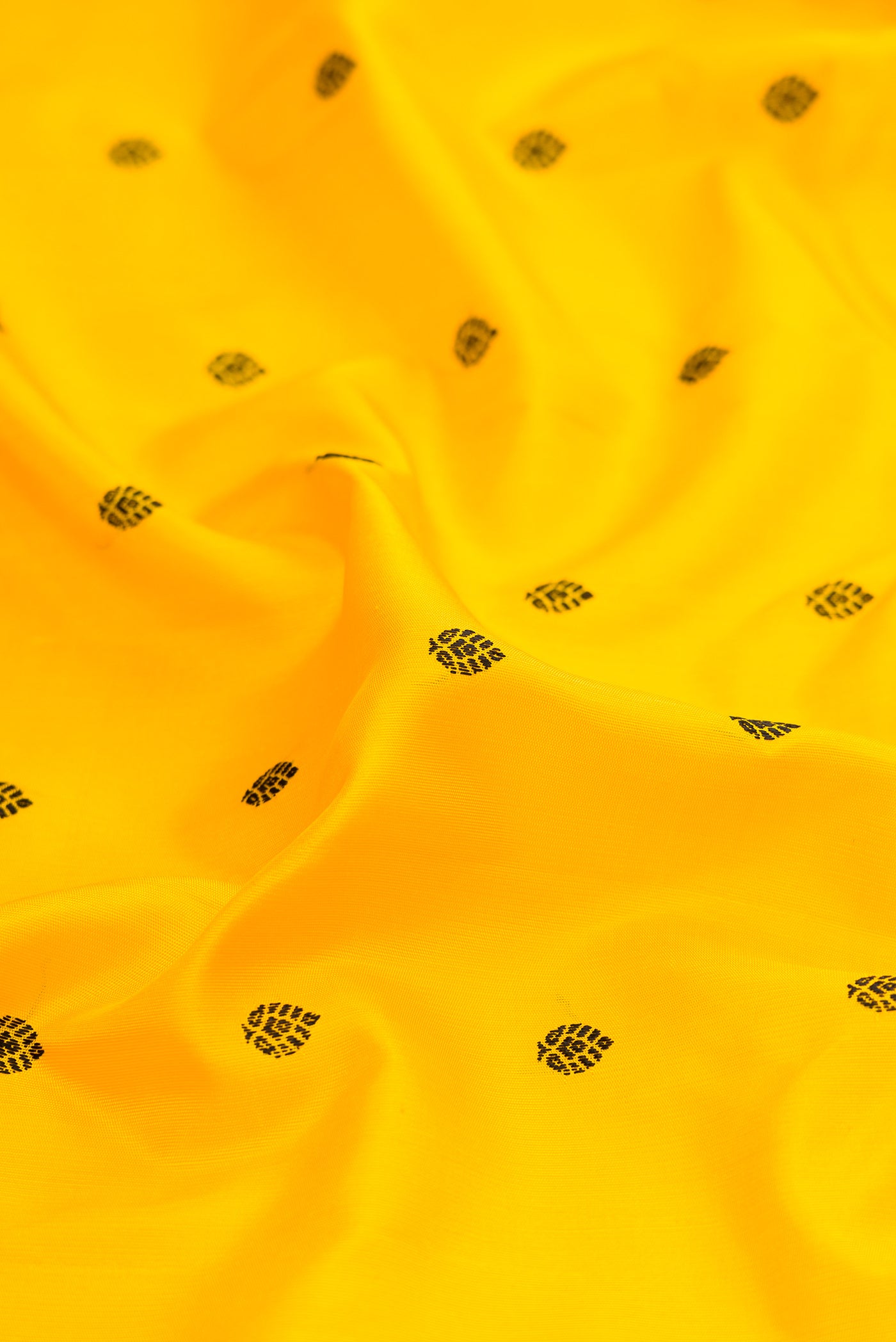 Close up of Yellow Gadwal Silk Saree with Thread Butta on the body and Temple Border.  displaying folds