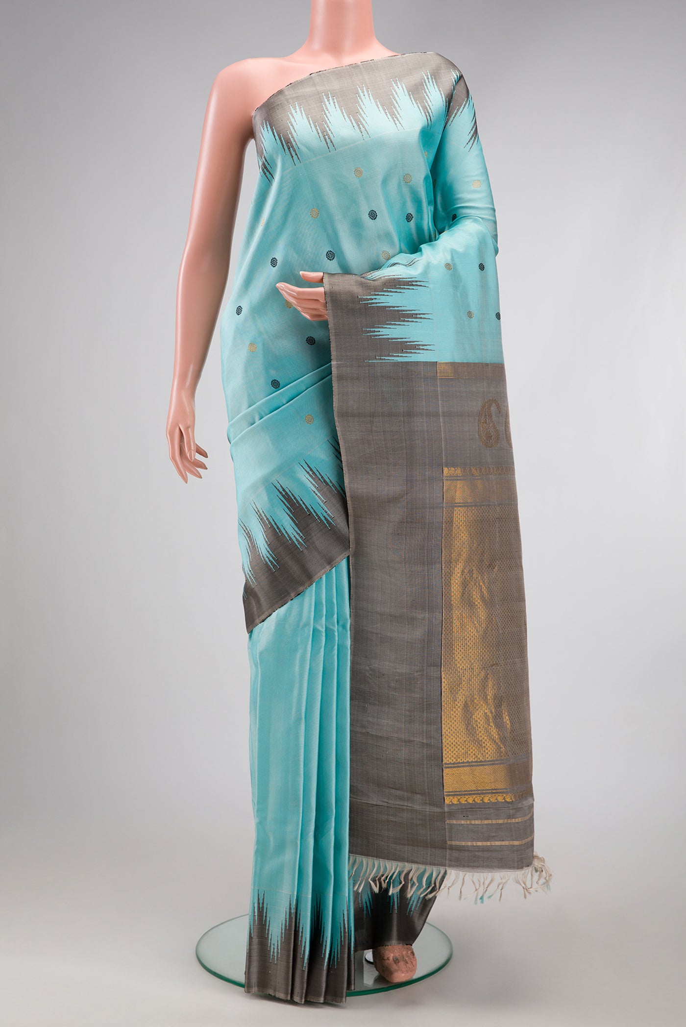 Sky Blue Gadwal Silk Saree with Zari And Thread Butta on the body and Temple Border.  displayed on a mannequin