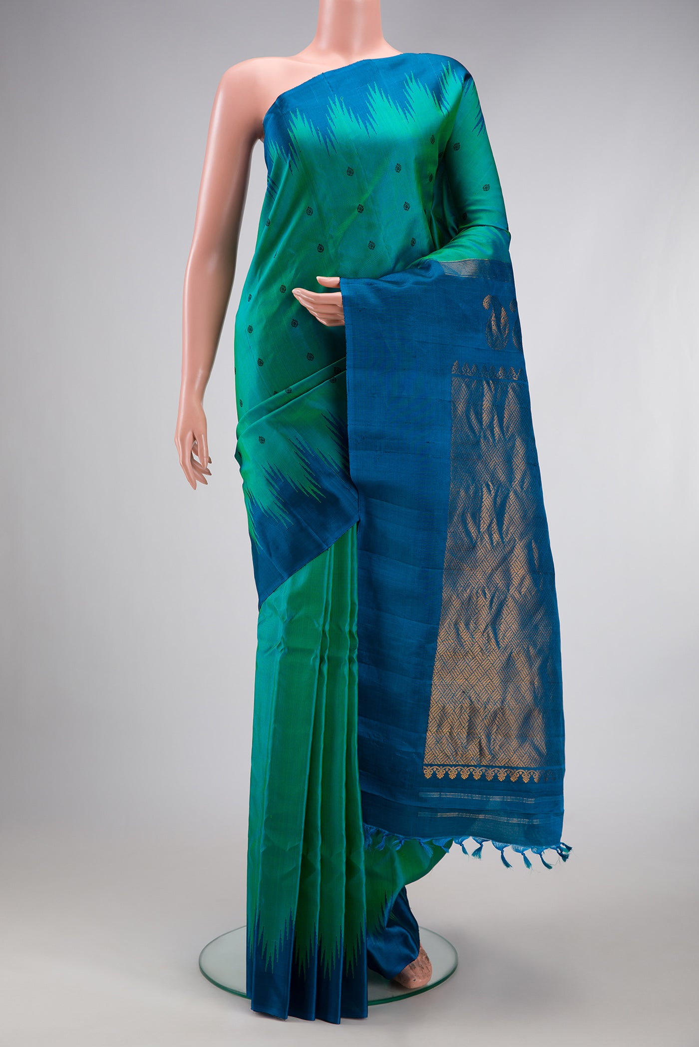 Sea Green Dual Tone Gadwal Silk Saree with Thread Butta on the body and Temple Border.  displayed on a mannequin