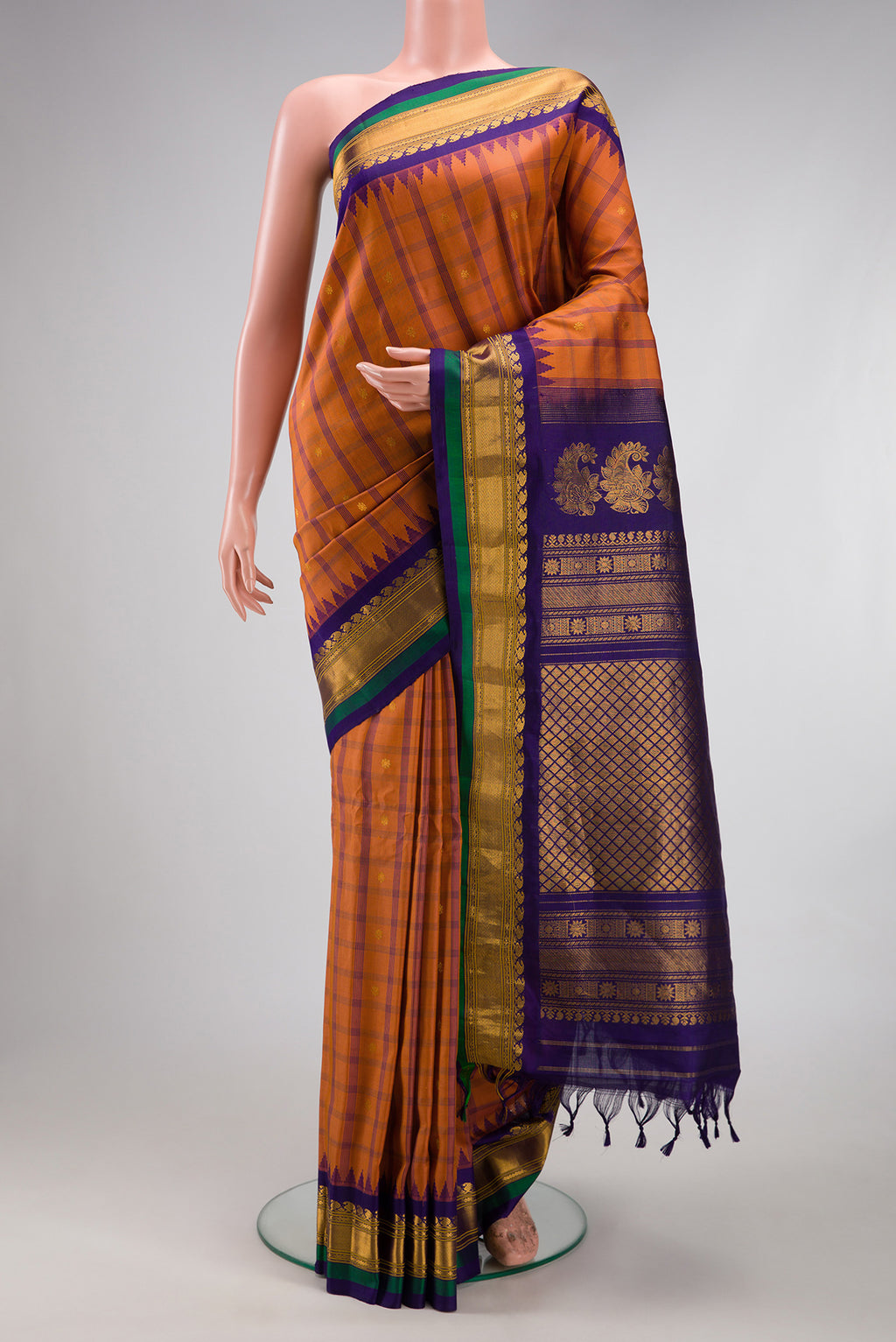 Brick Orange Gadwal Silk Saree with Checked design on the body and Zari Border.  displayed on a mannequin