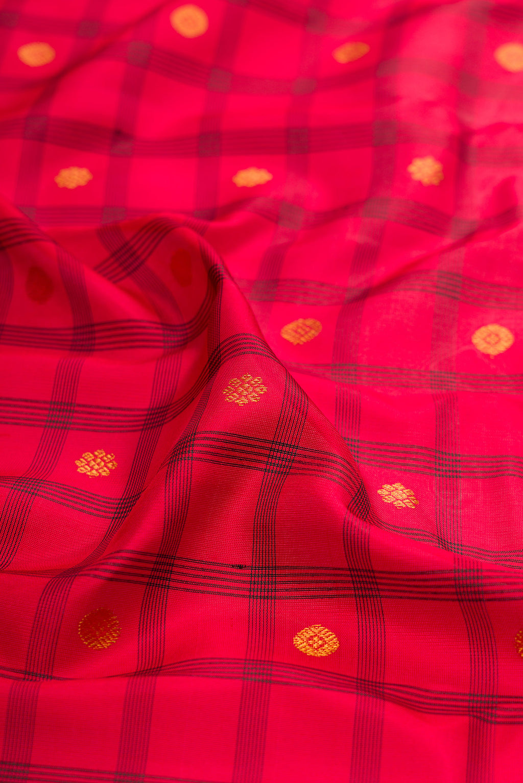 Close up of Red Gadwal Silk Saree with Checked design on the body and Temple Border.  displaying folds