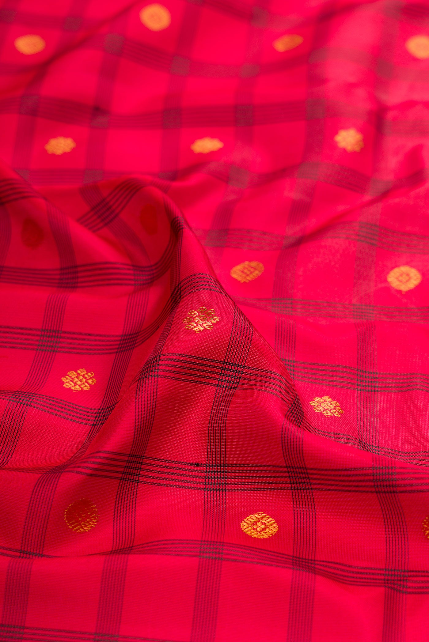 Close up of Red Gadwal Silk Saree with Checked design on the body and Temple Border.  displaying folds