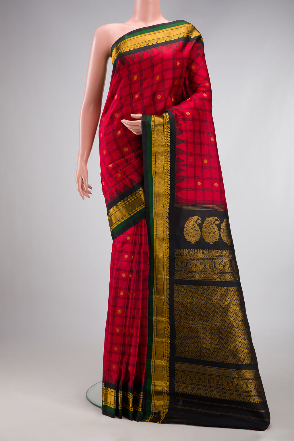 Red Gadwal Silk Saree with Checked design on the body and Temple Border.  displayed on a mannequin