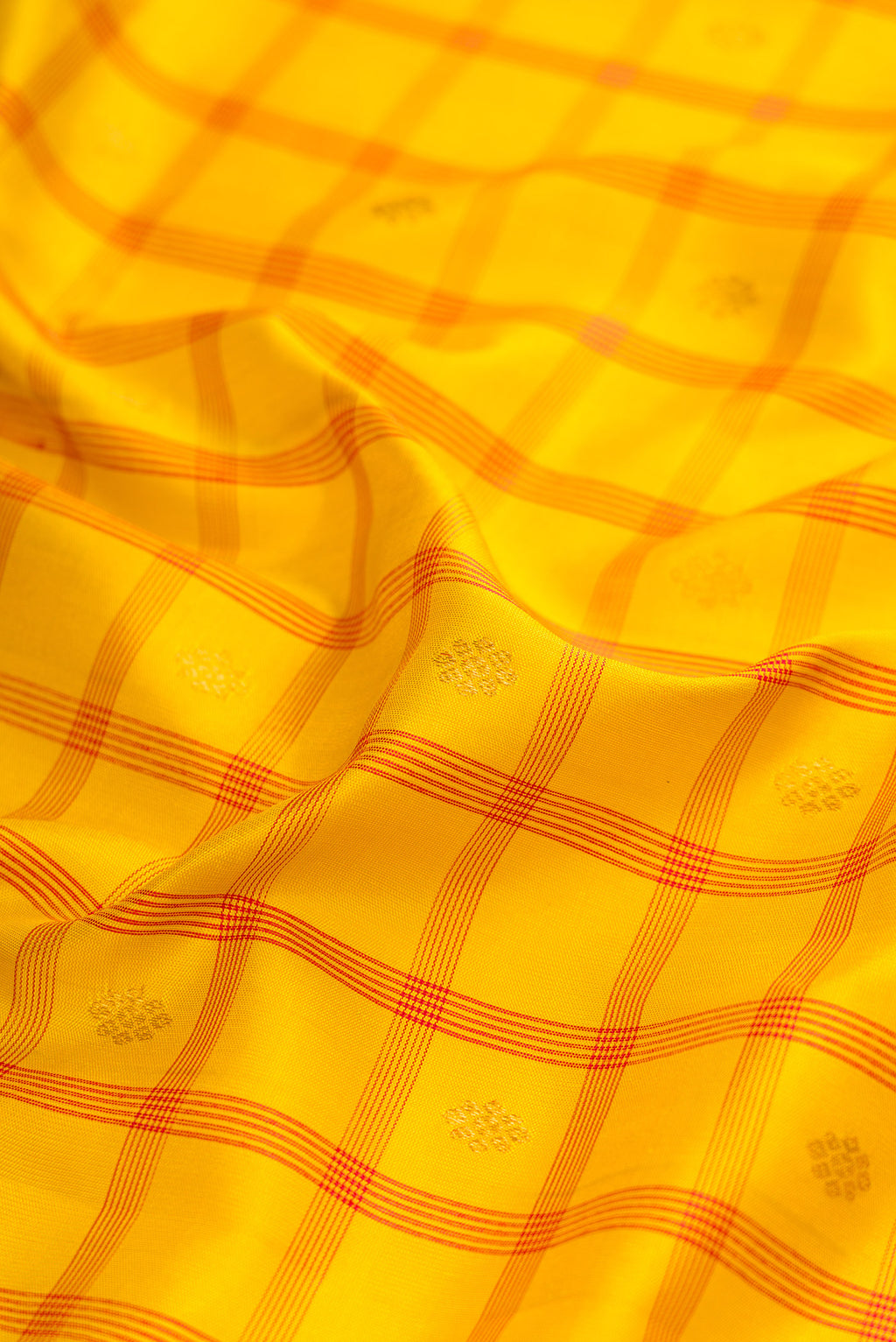 Close up of Yellow Gadwal Silk Saree with Checked design on the body and Zari Border.  displaying folds