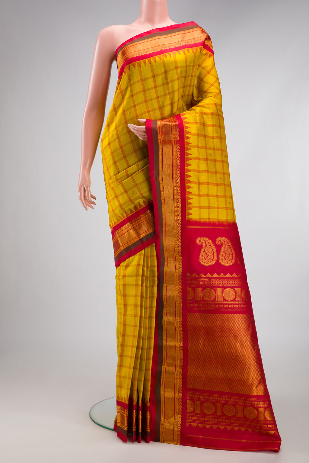 Yellow Gadwal Silk Saree with Checked design on the body and Zari Border.  displayed on a mannequin
