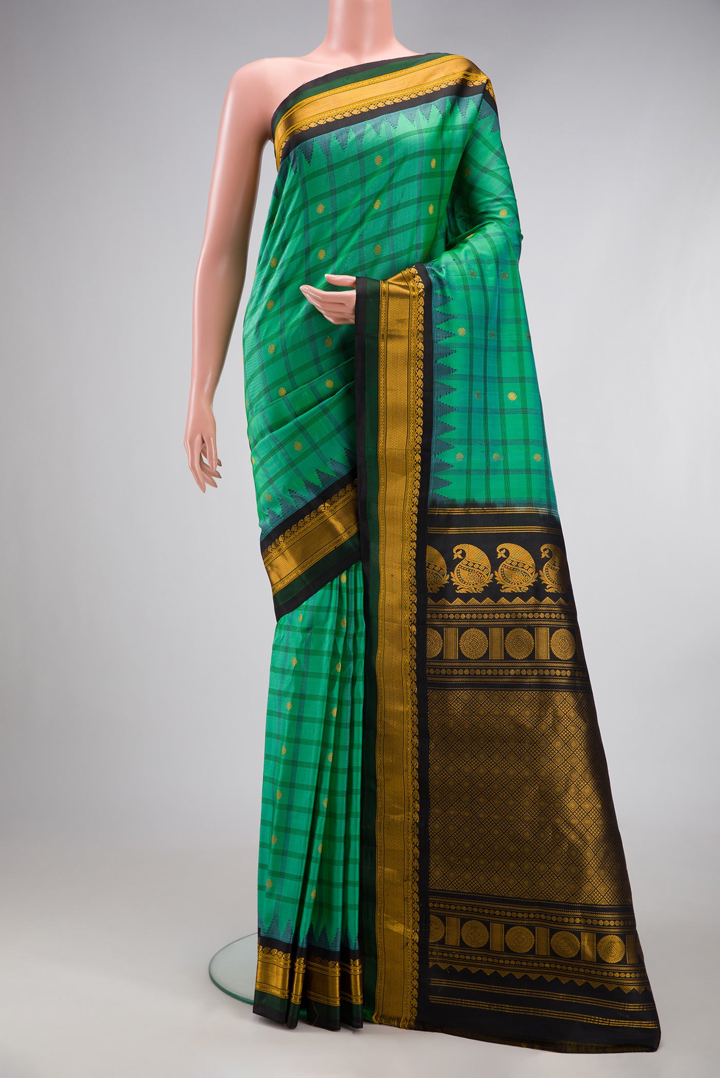 Sea Green Gadwal Silk Saree with Checked design on the body and Temple Border.  displayed on a mannequin