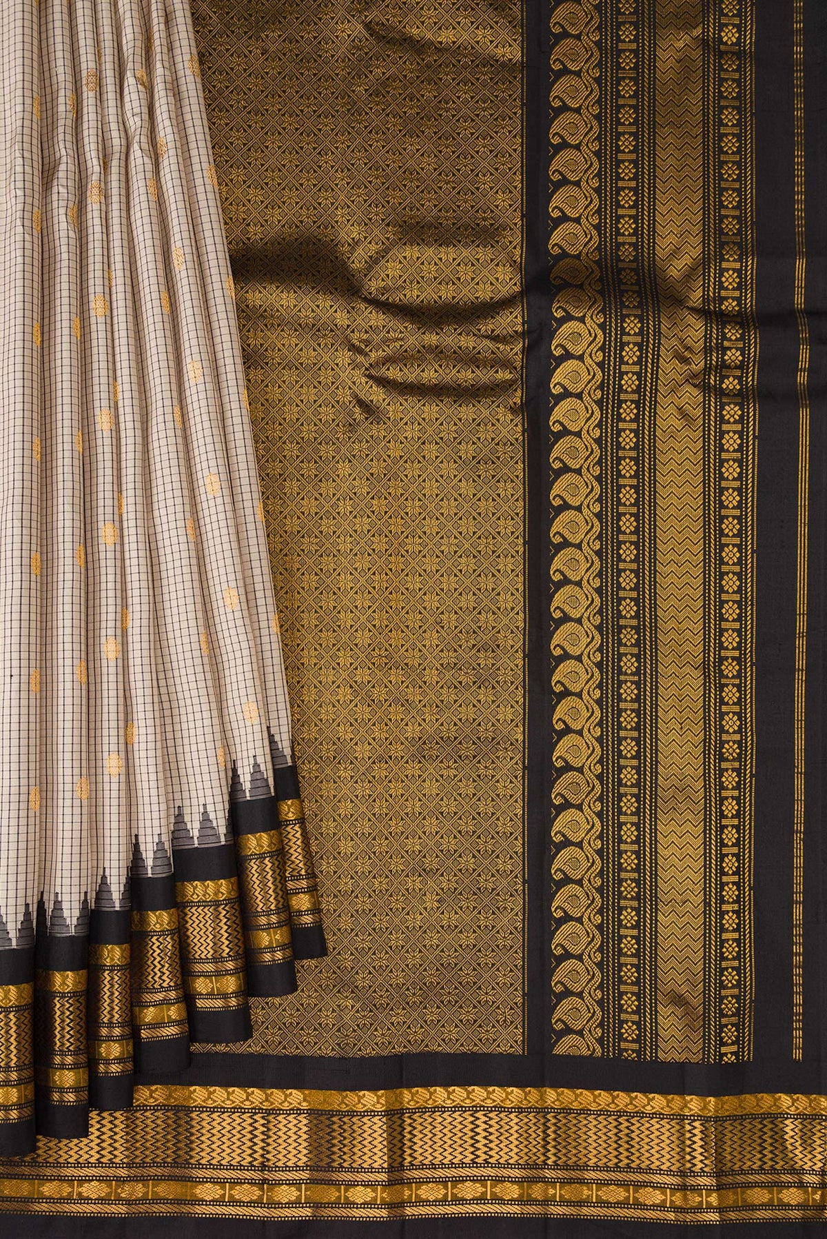 Pleats and pallu of Beige Gadwal Silk Saree with Checked design on the body and Temple Border. 
