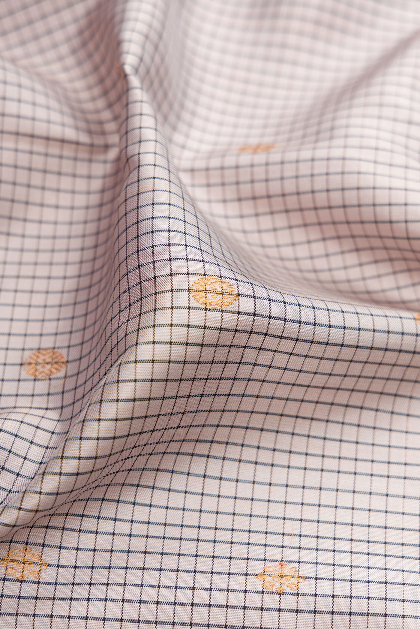 Close up of Grey Gadwal Silk Saree with Checked design on the body and Temple Border.  displaying folds