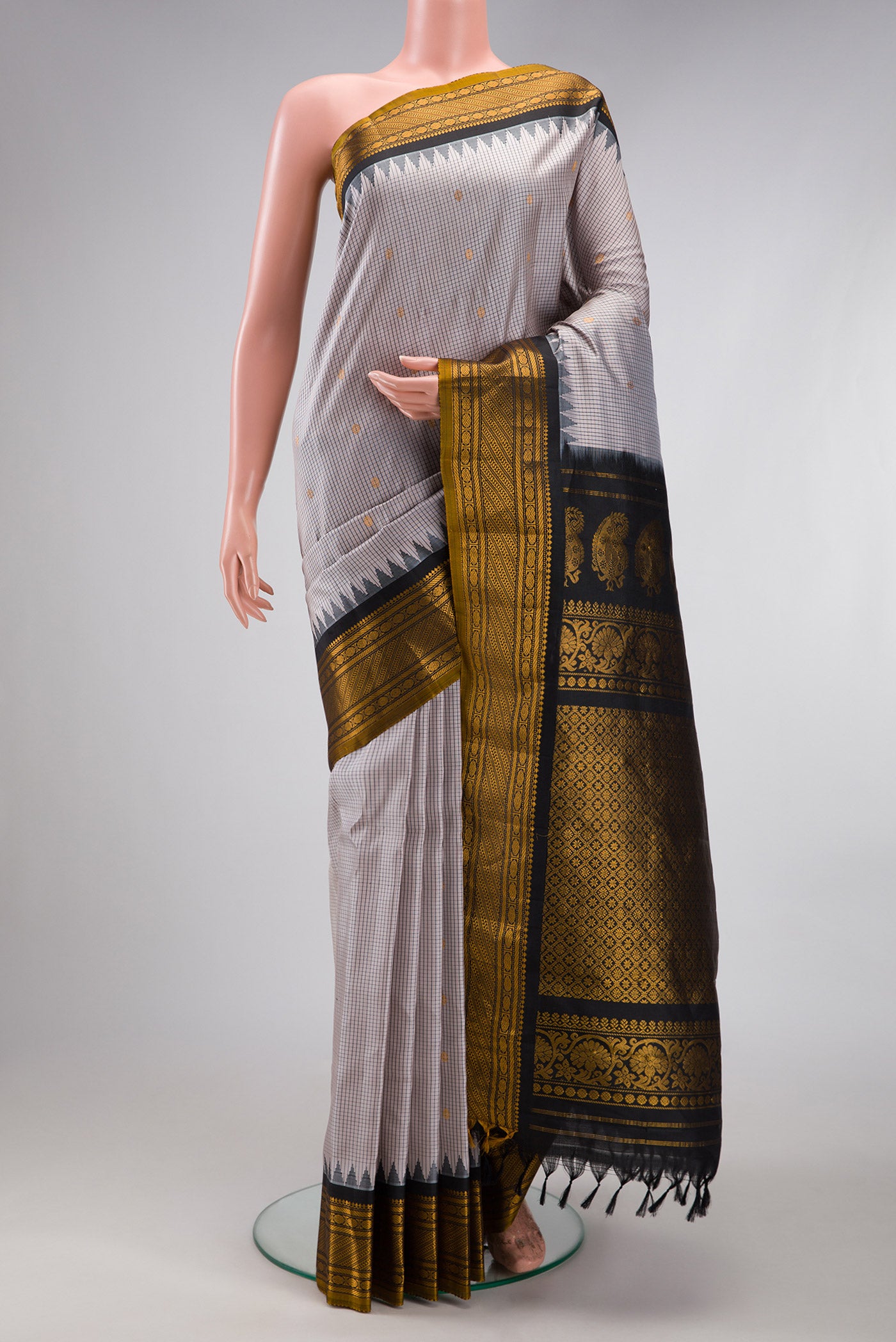 Grey Gadwal Silk Saree with Checked design on the body and Temple Border.  displayed on a mannequin