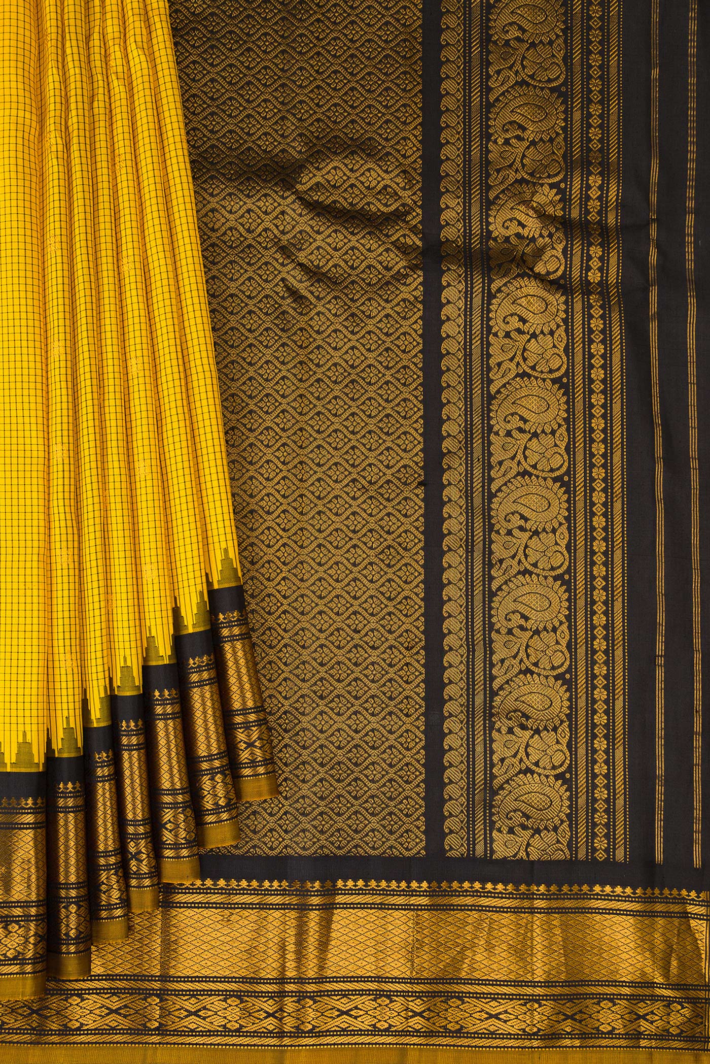 Pleats and pallu of Yellow Gadwal Silk Saree with Checked design on the body and Temple Border. 