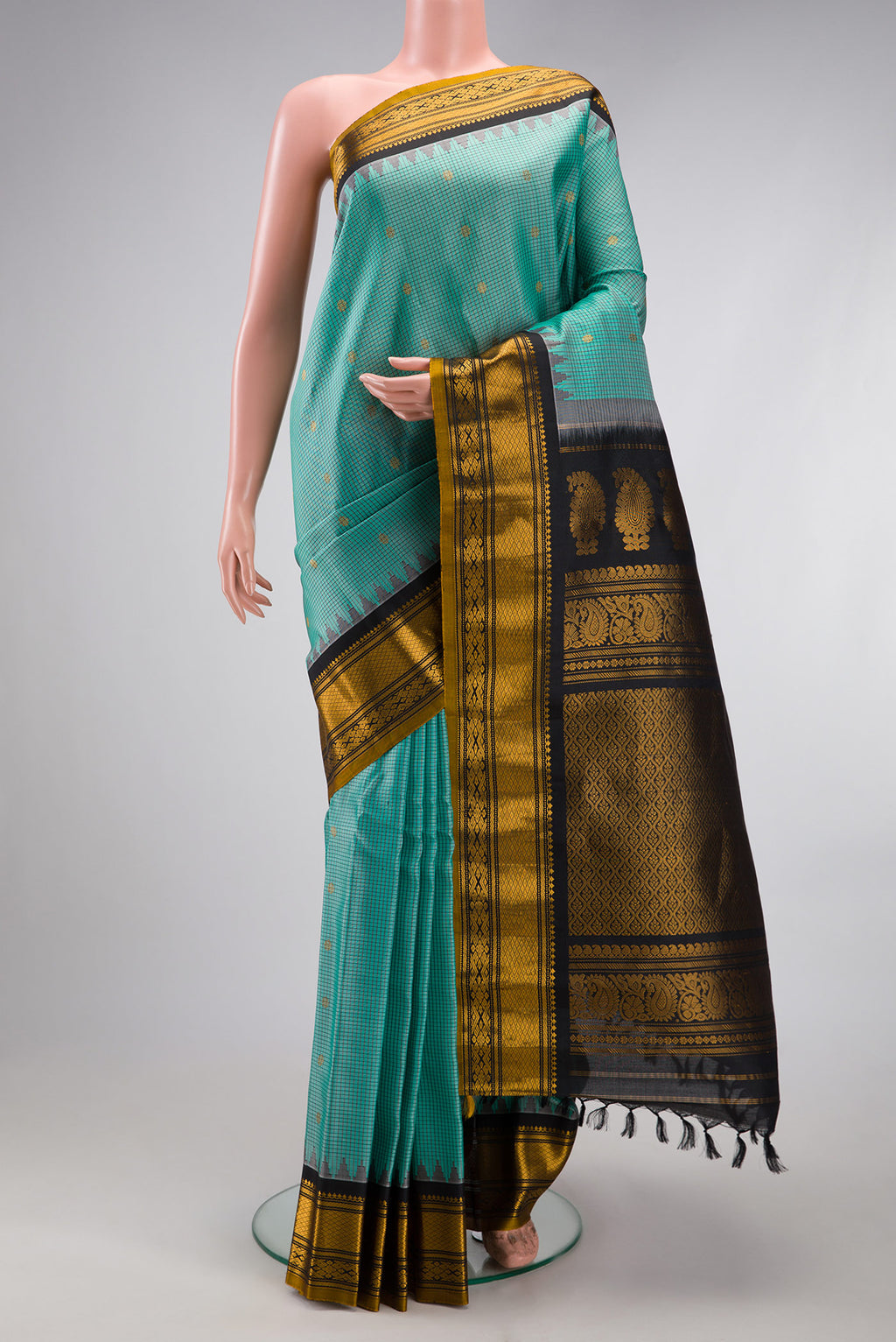 Sea Green Gadwal Silk Saree with Checked design on the body and Temple Border.  displayed on a mannequin