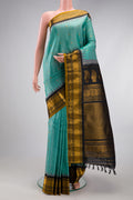Sea Green Gadwal Silk Saree with Checked design on the body and Temple Border.  displayed on a mannequin