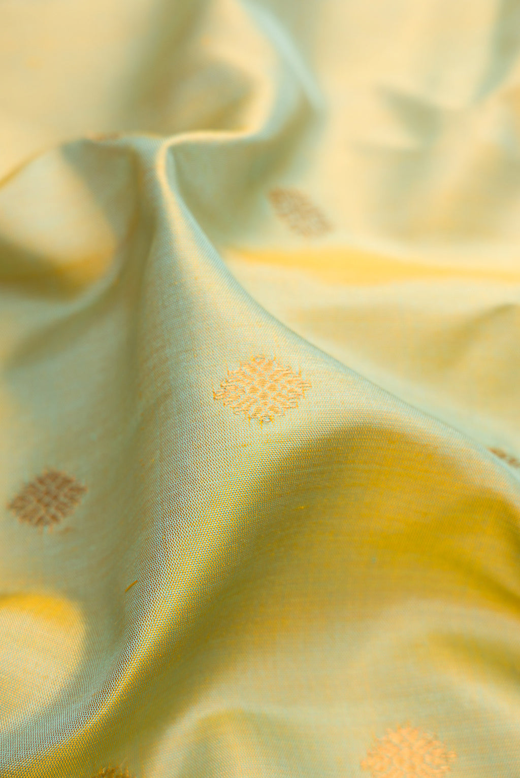Close up of Mehandi Green Dual Tone Gadwal Silk Saree with Zari Butta on the body and Temple Border.  displaying folds